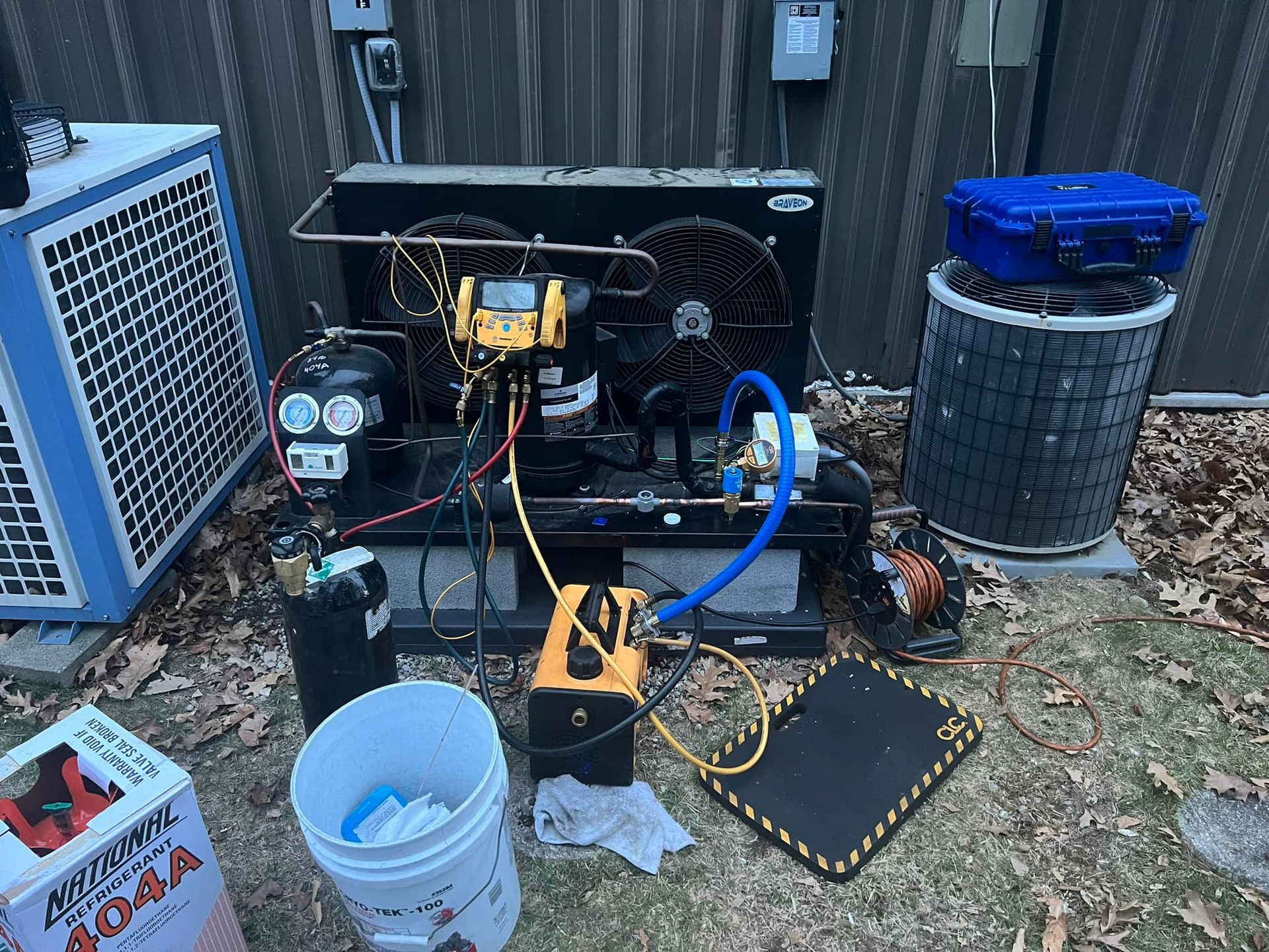 an air conditioner is being repaired outside of a building .