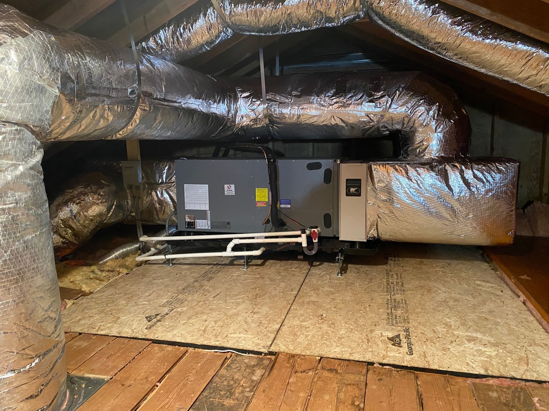 an air conditioner is installed in the attic of a house .