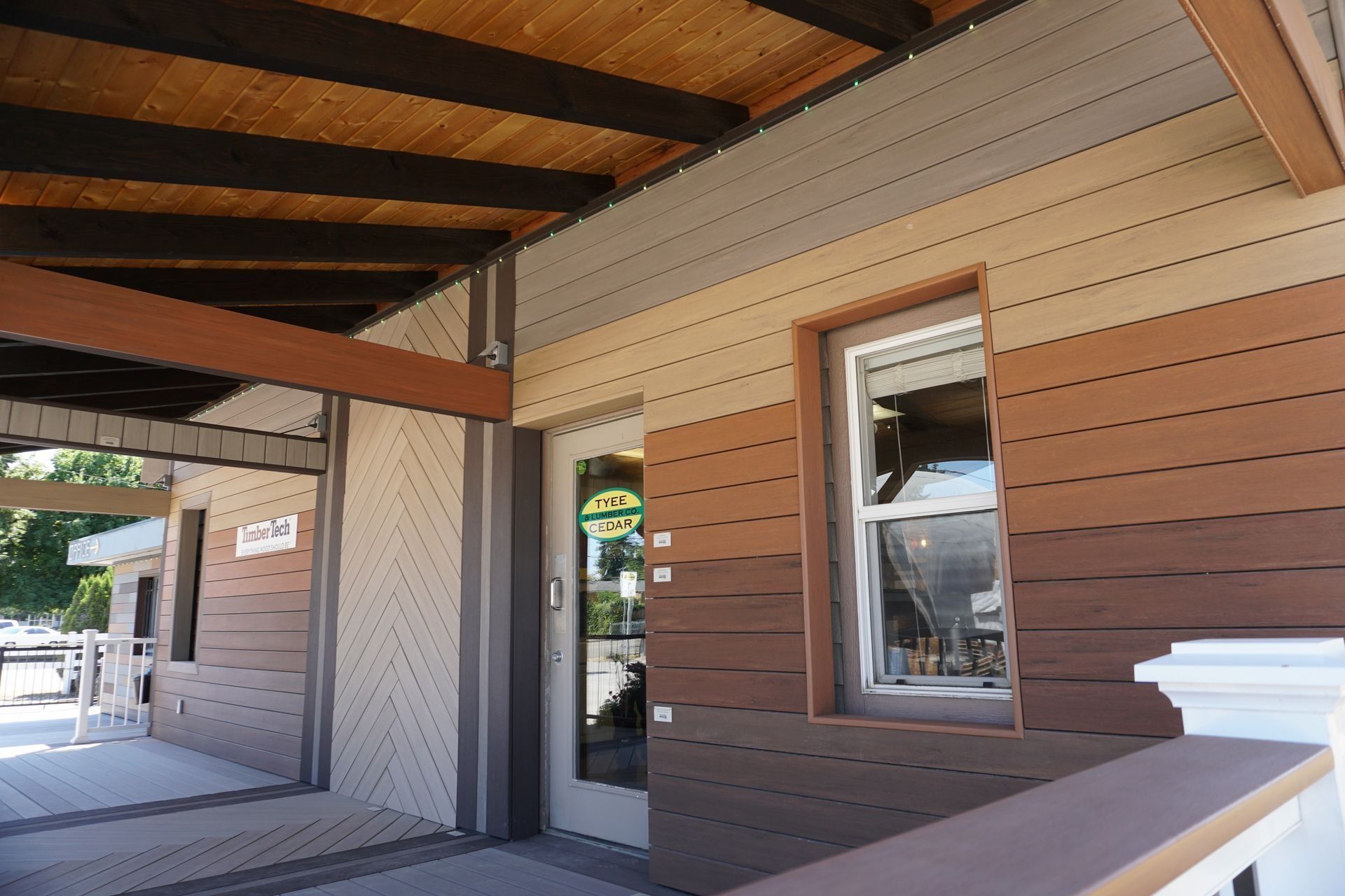 Building exterior with multi-toned horizontal siding, window, and covered porch.