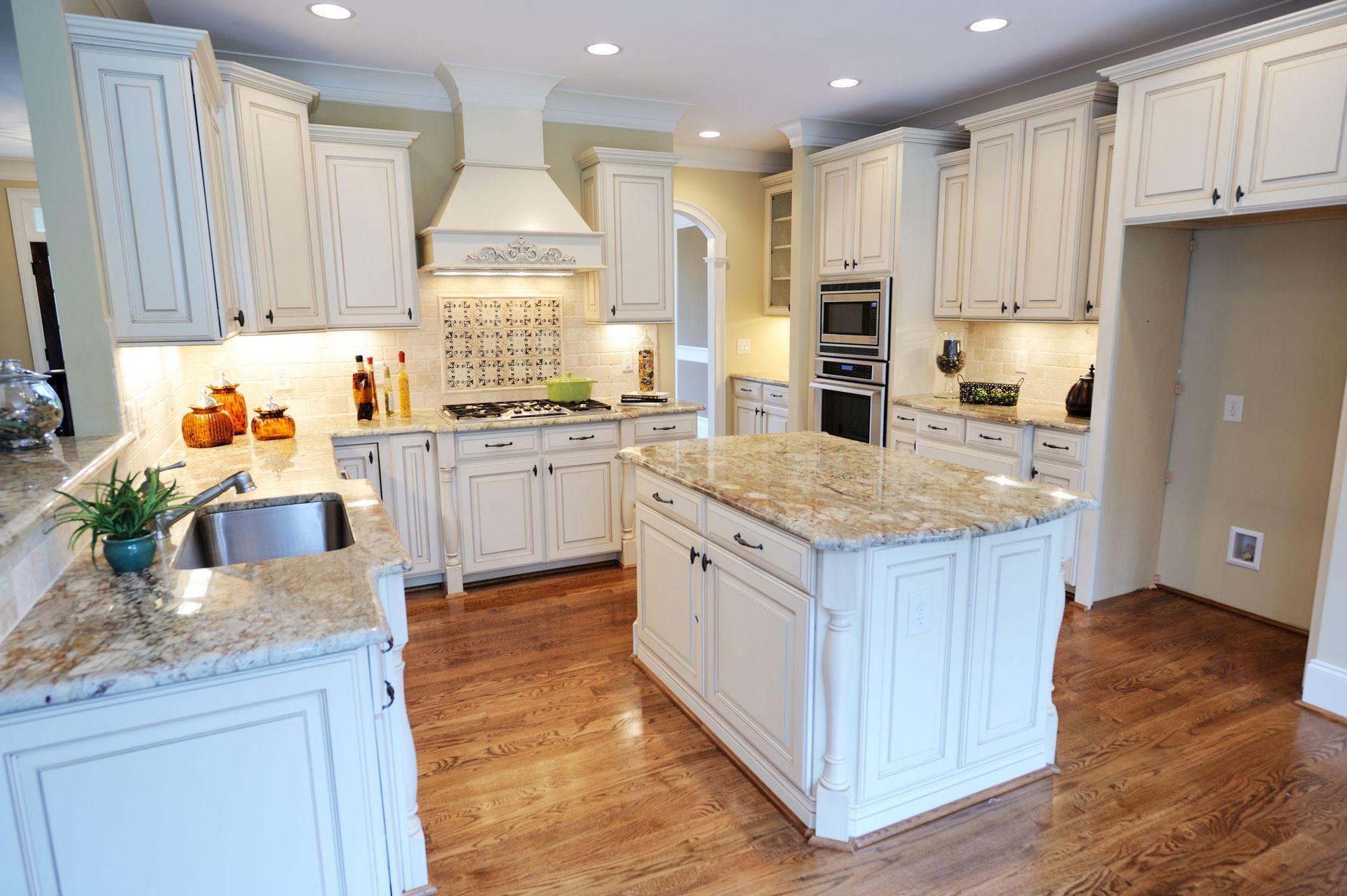 Modern kitchen with wooden cabinets and granite countertops showcasing cabinet resurfacing in Frankl