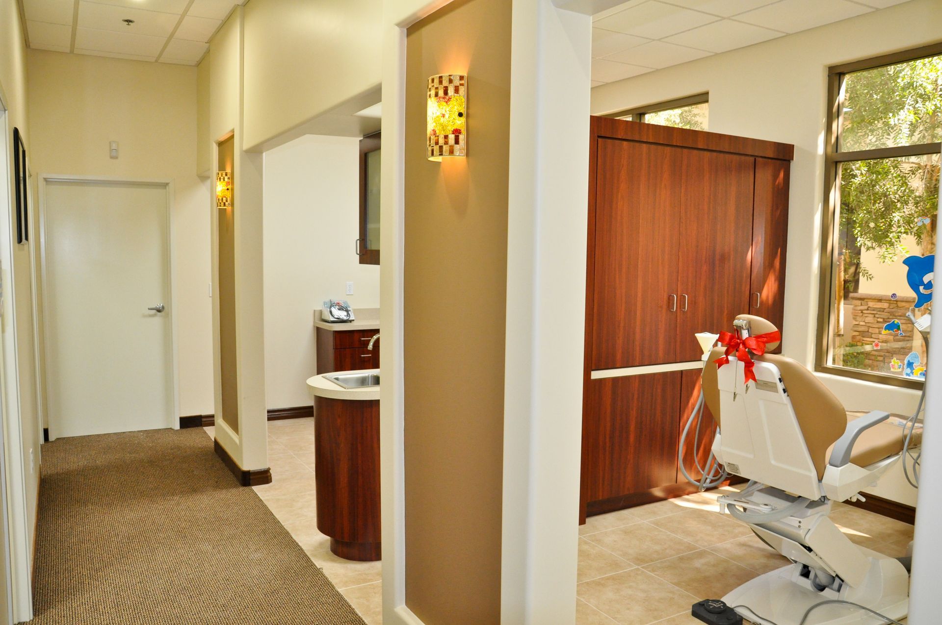 Hallway in a dental office with an open examination room.