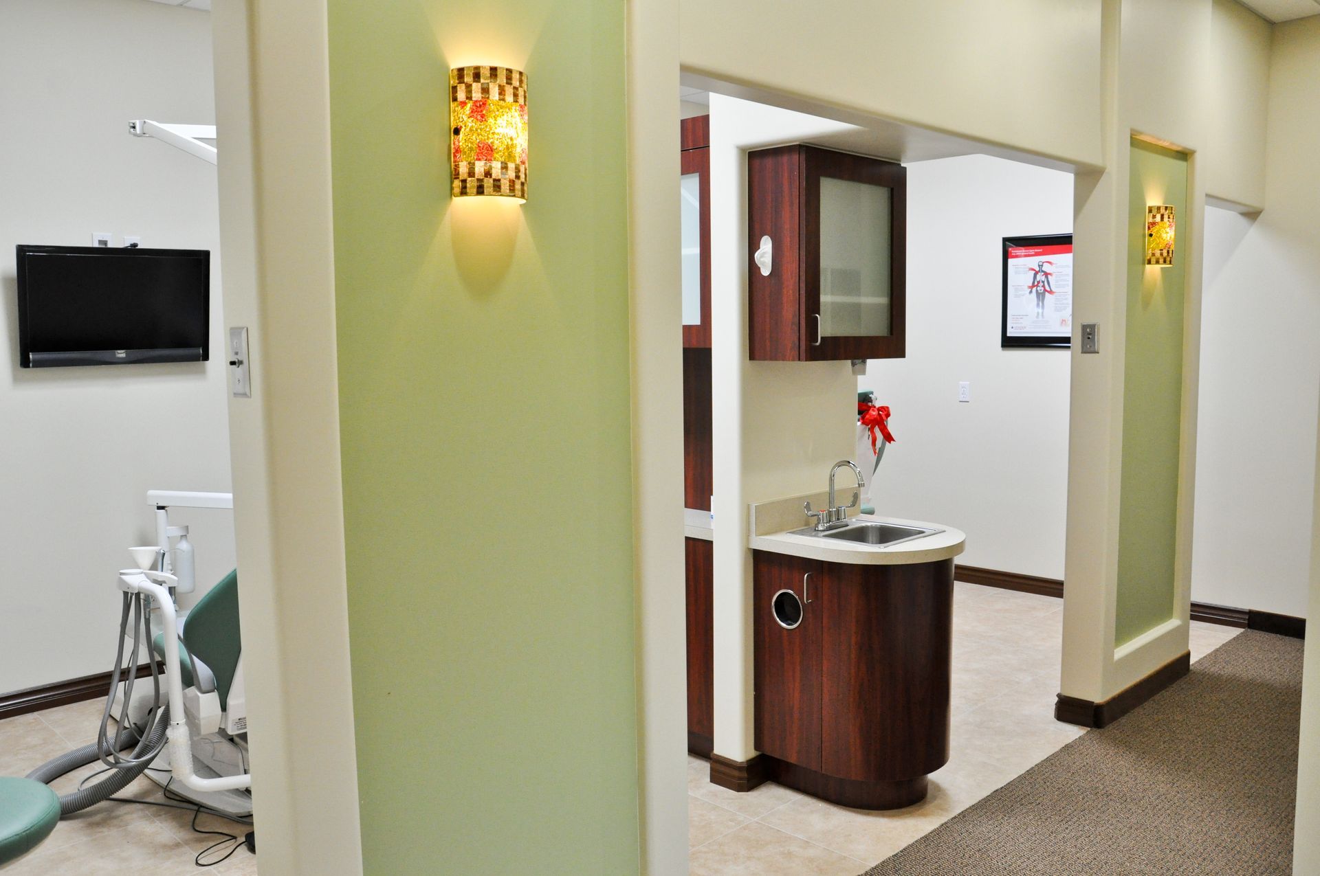Dental office hallway with exam room and sink areas visible.