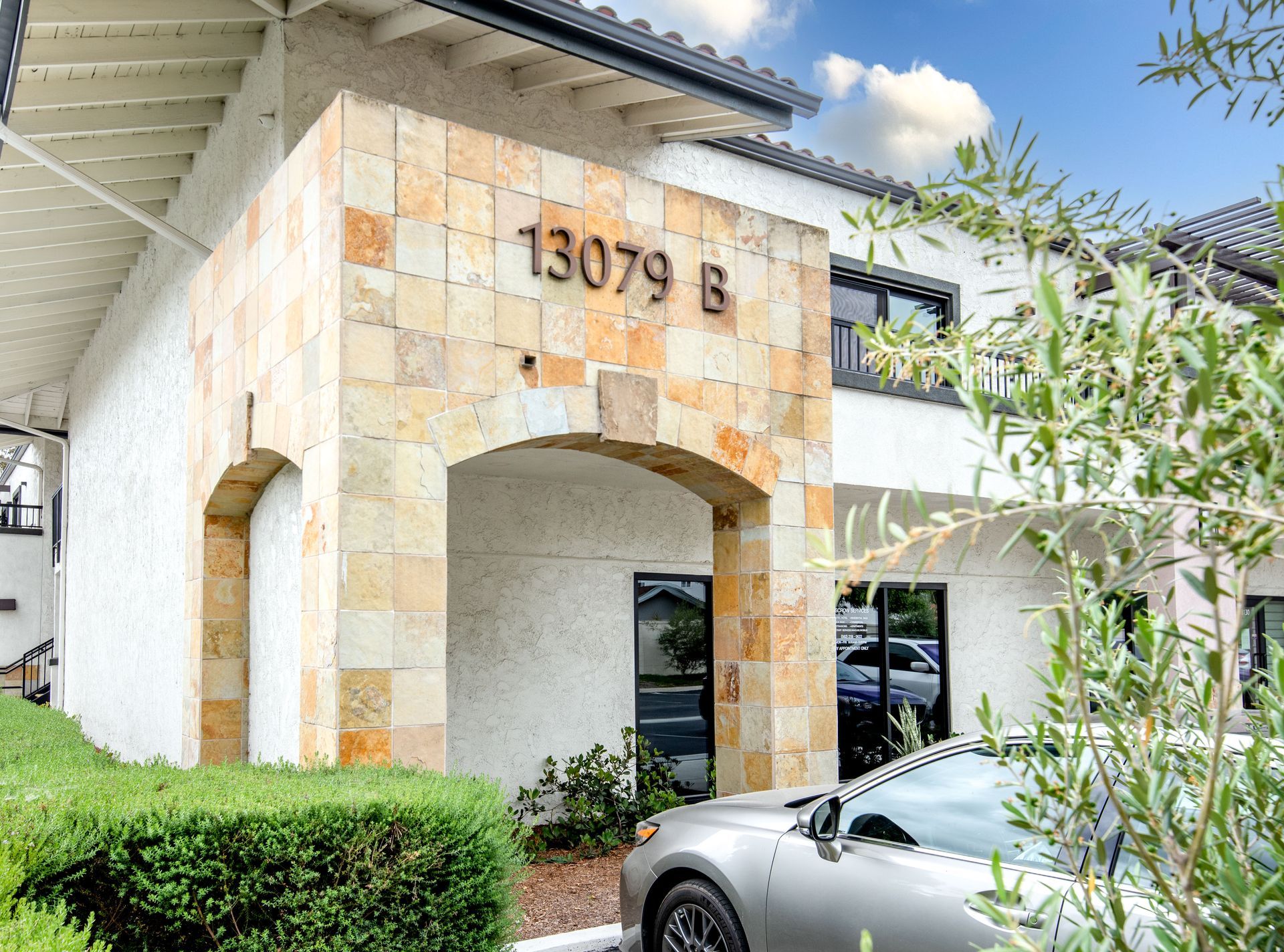 Building entrance with stone archway, address 