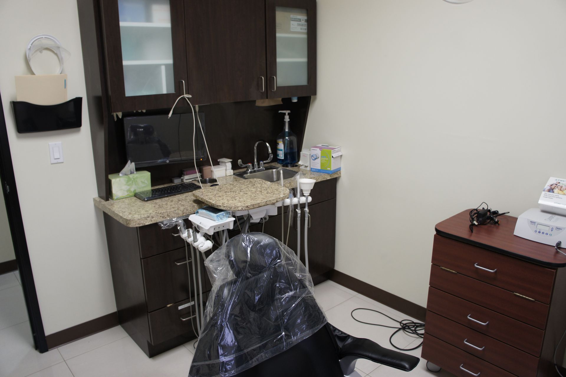 Dental office examination room with dental chair and equipment.