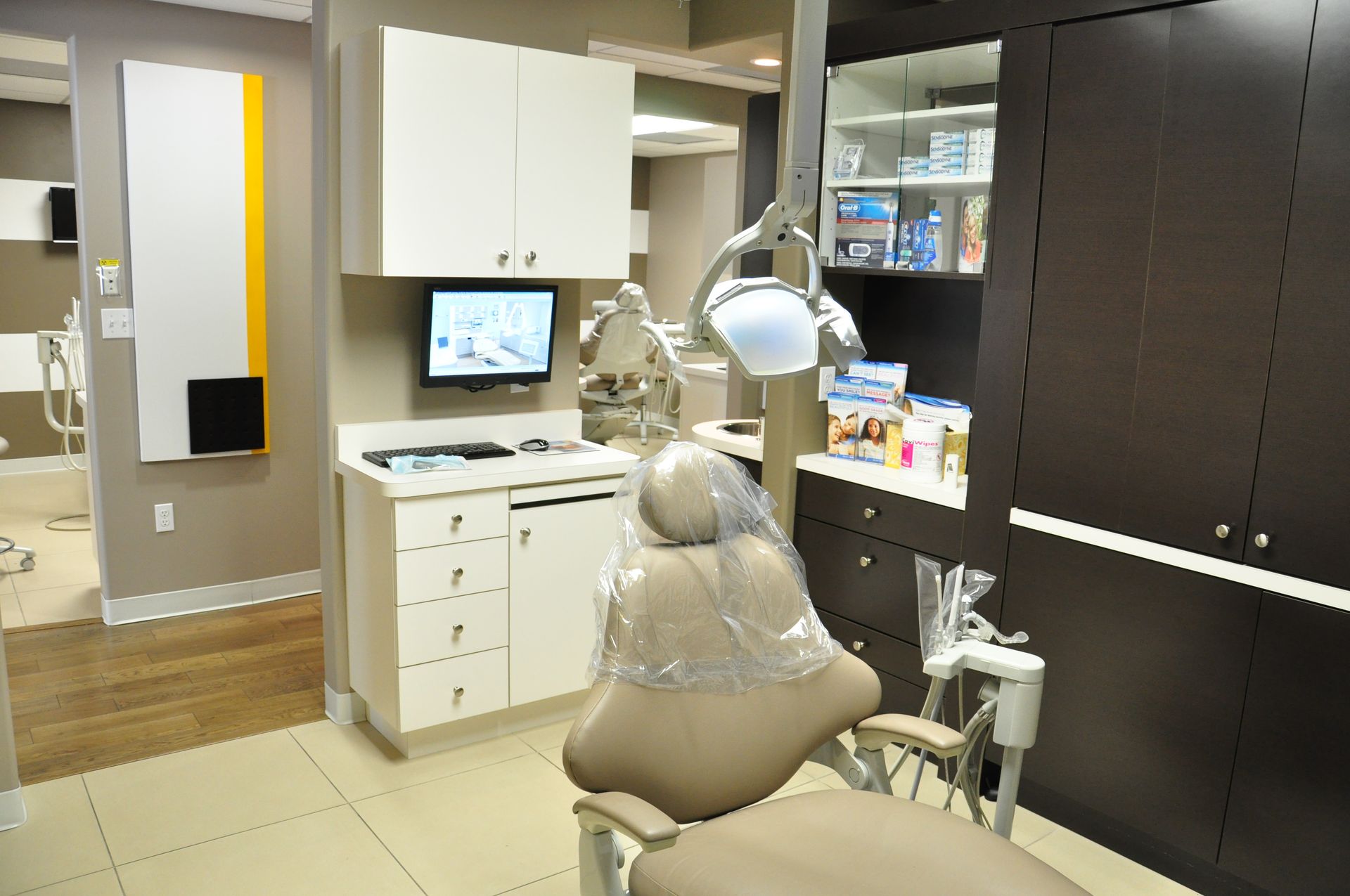 Dental operatory room with a chair, cabinets, and equipment.