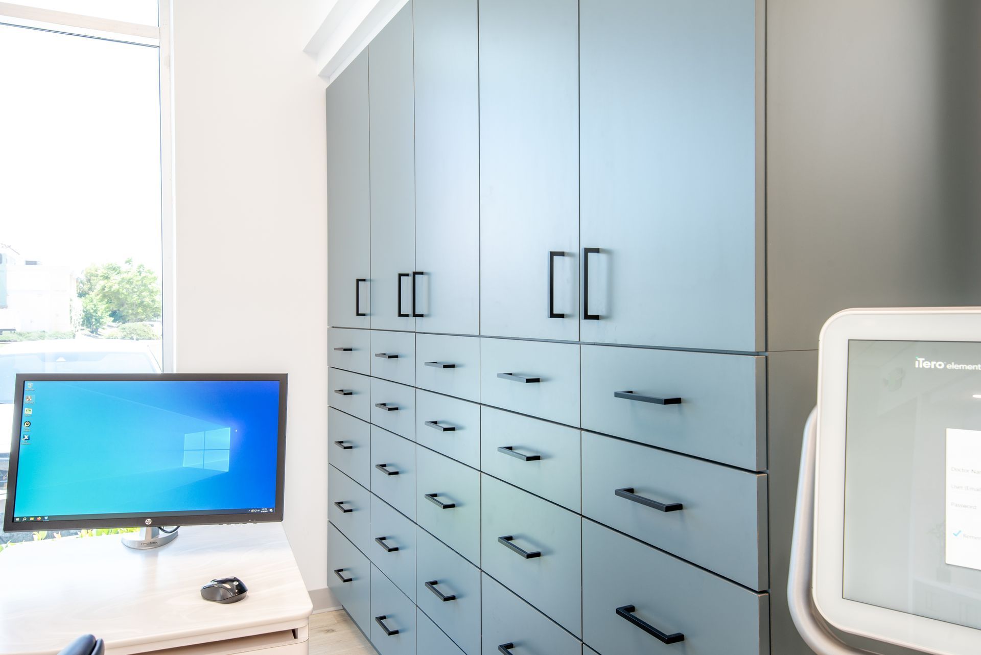 Office storage cabinets and drawers; desk with computer monitor.