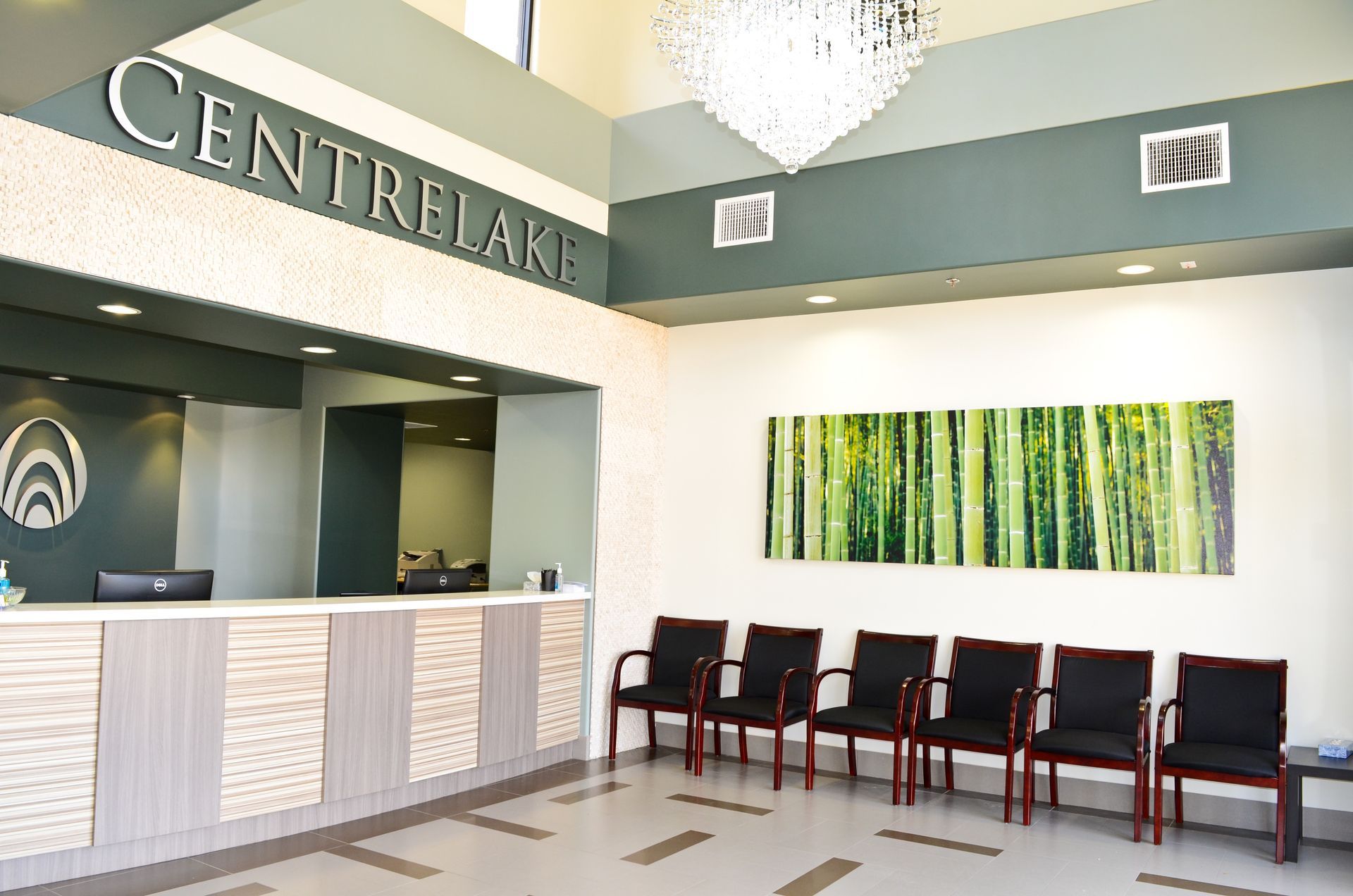 Reception area of Centre Lake with front desk, seating, and art.