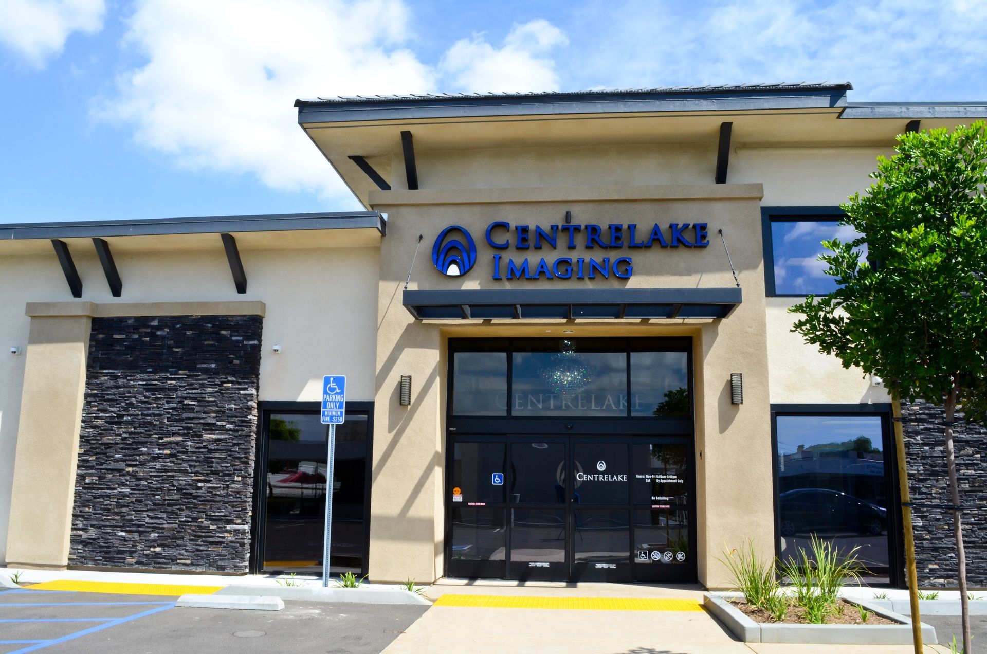 CentreLake Imaging building with black doors and stone facade; blue logo and accessible parking.