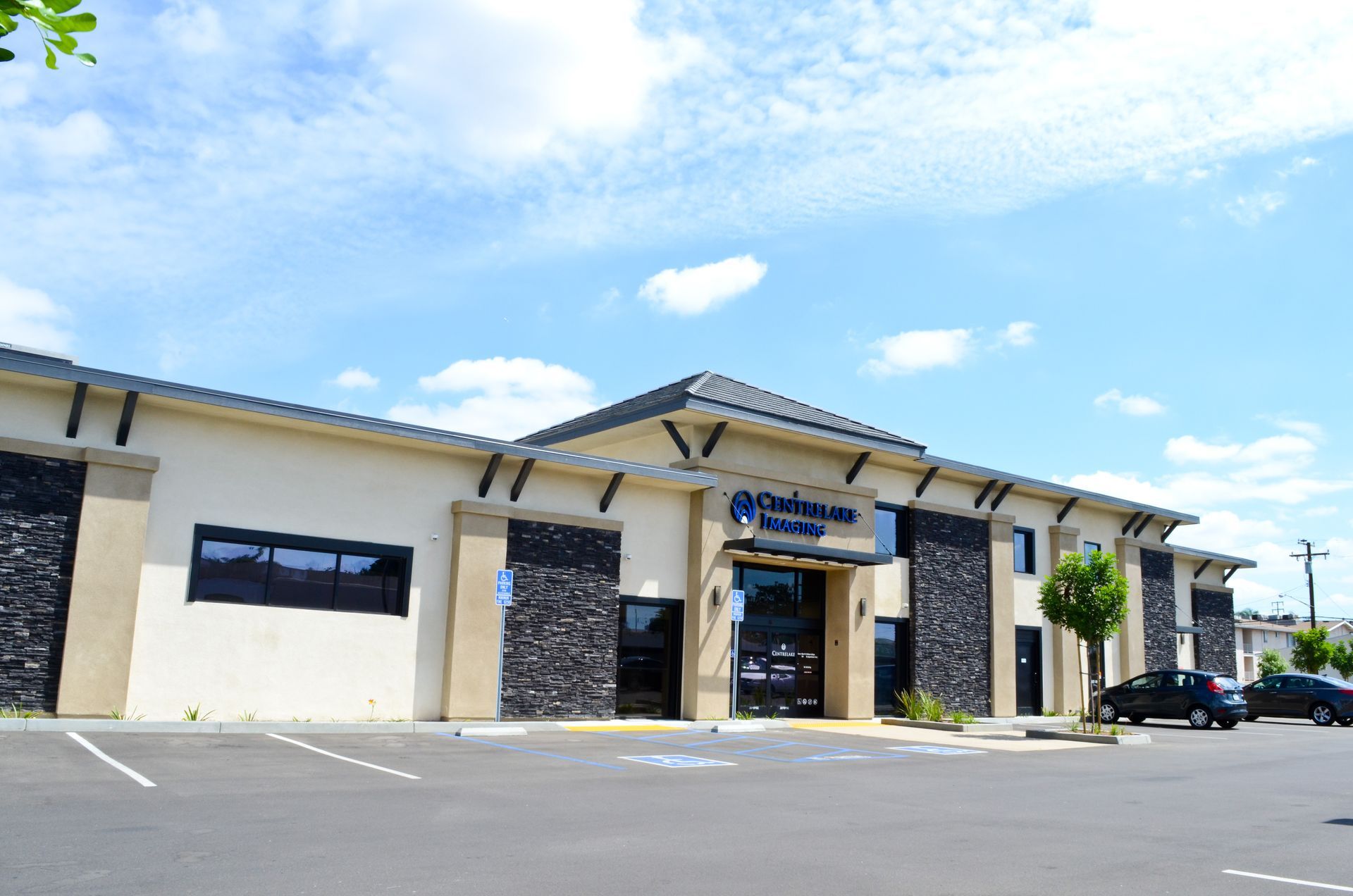 Exterior view of the Oak Island Physical Therapy clinic building with blue sky and parked cars.
