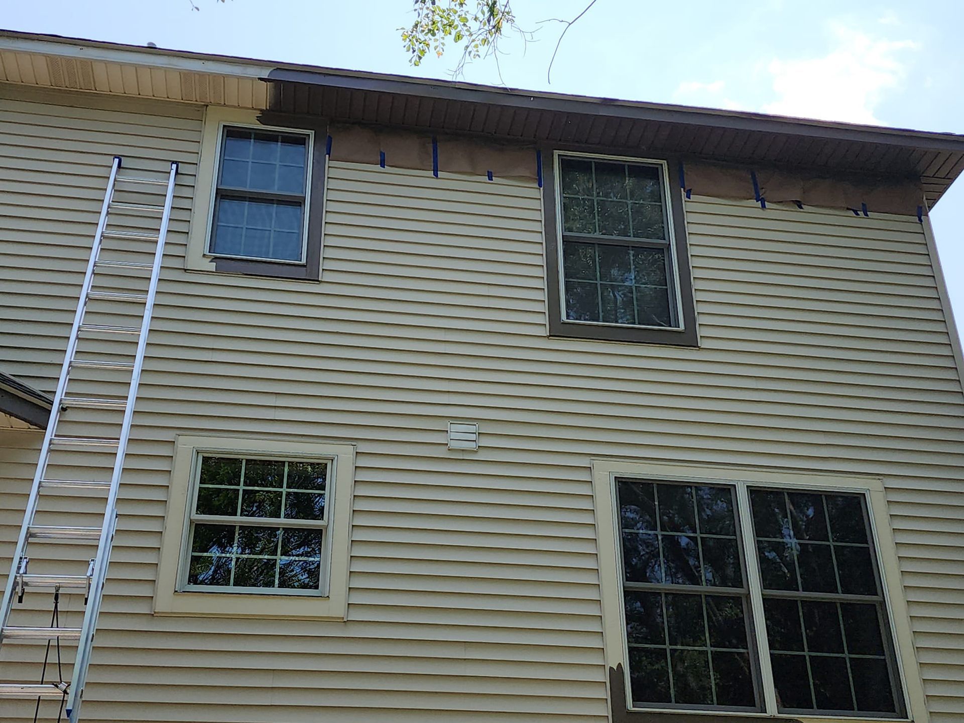 A house with a ladder on the side of it