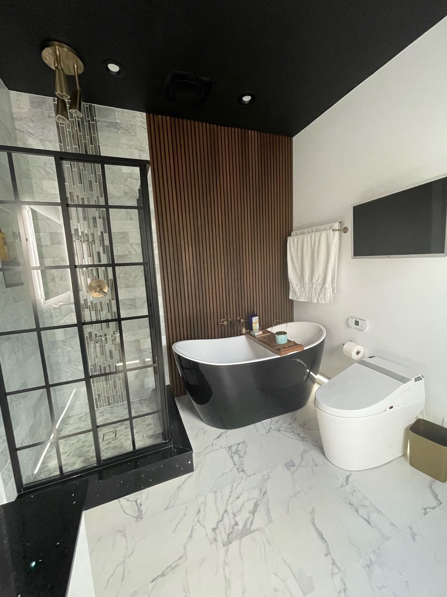 Modern kitchen with white cabinets, stainless steel appliances, and a granite countertop.