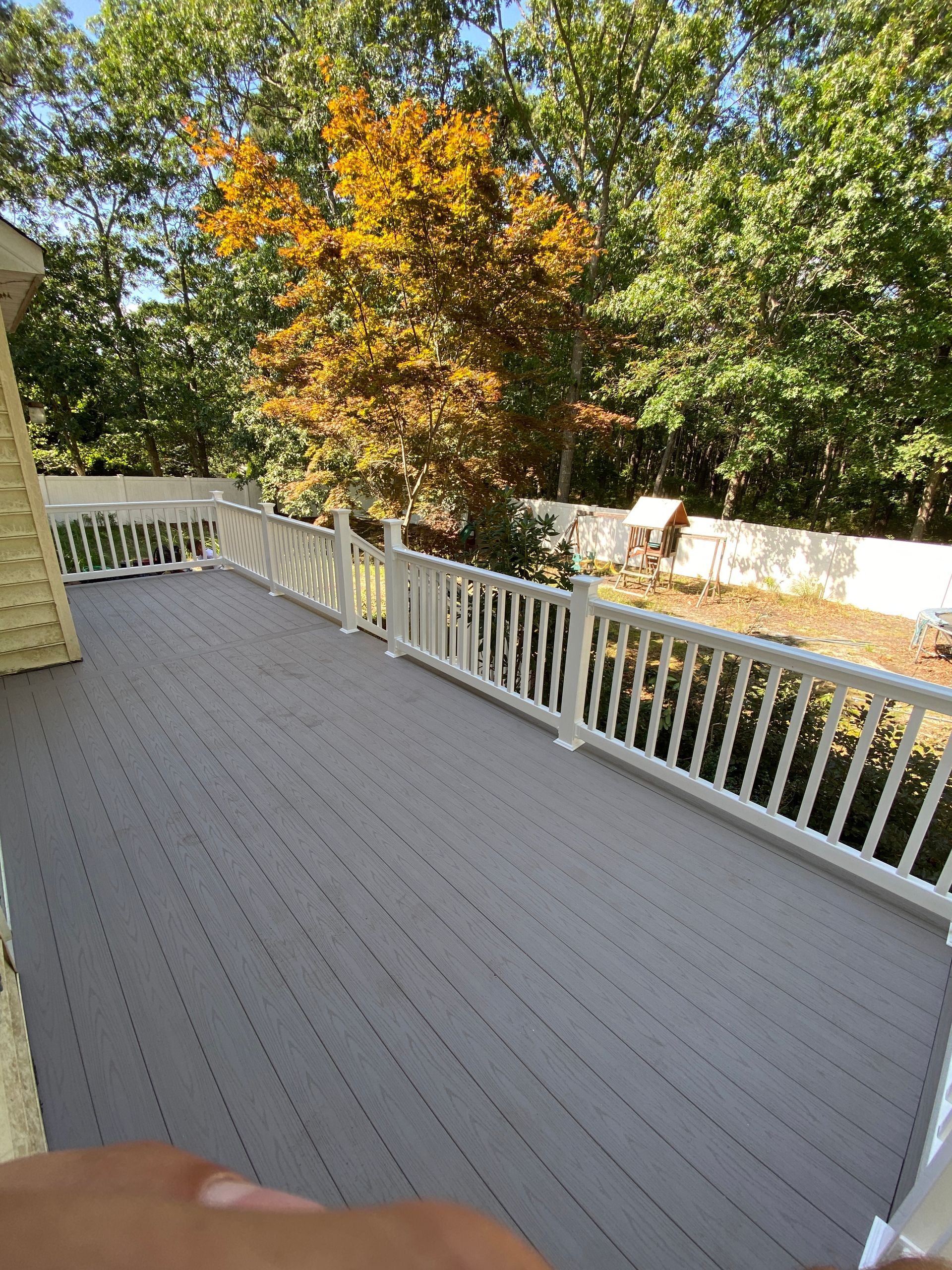 a deck with trees next to it