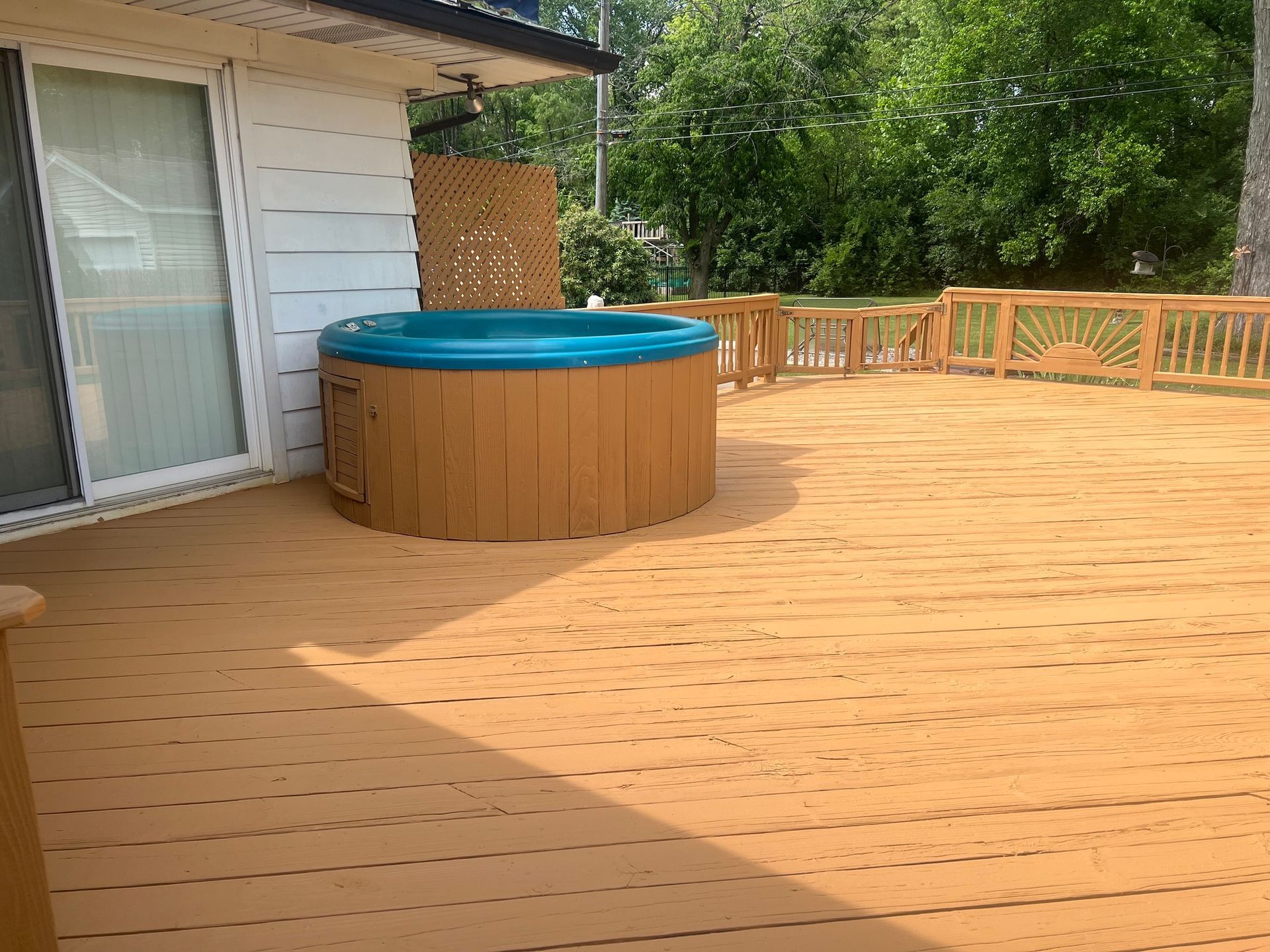 There is a hot tub on the deck of a house.