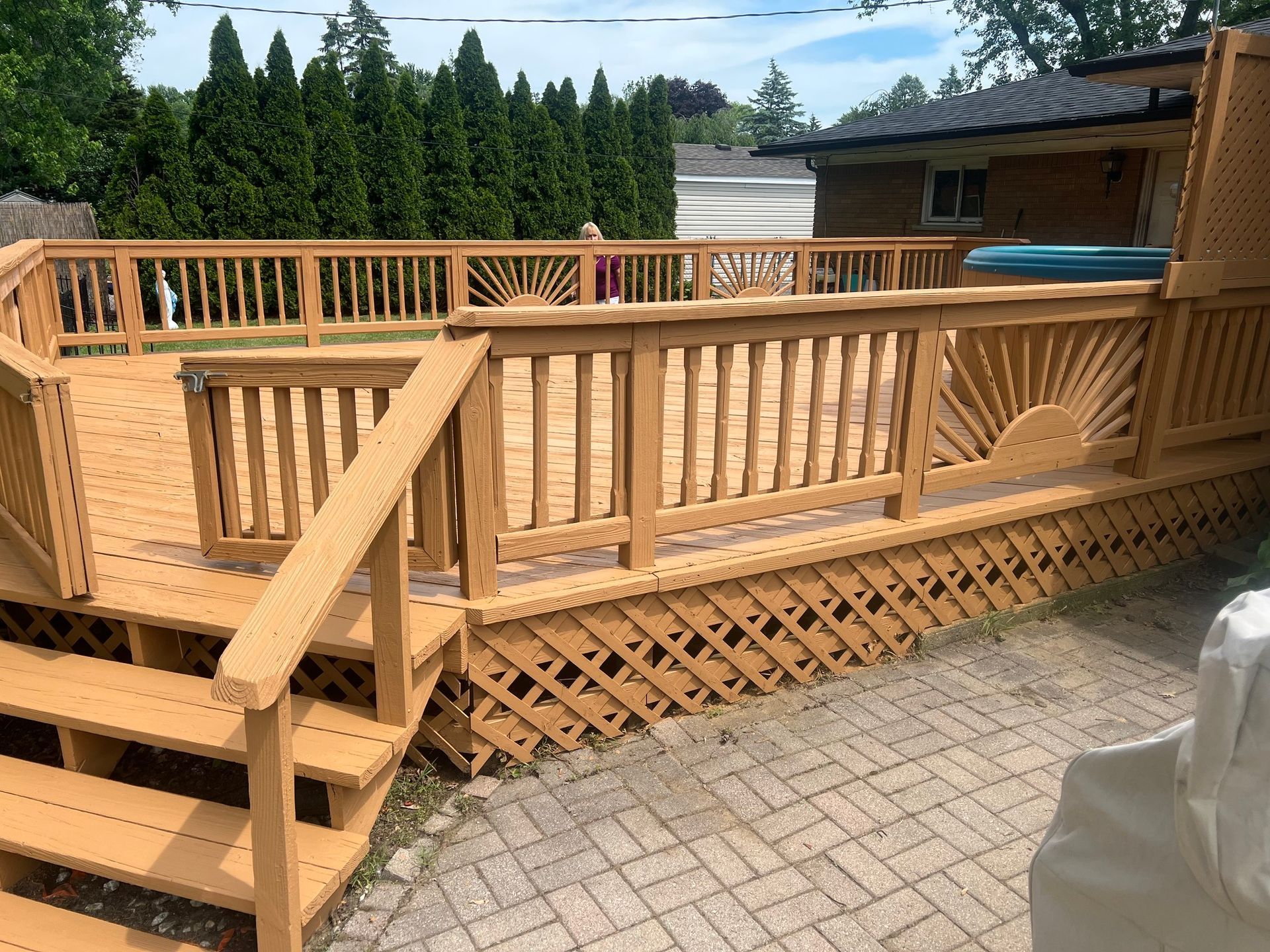A large wooden deck with stairs leading up to it.