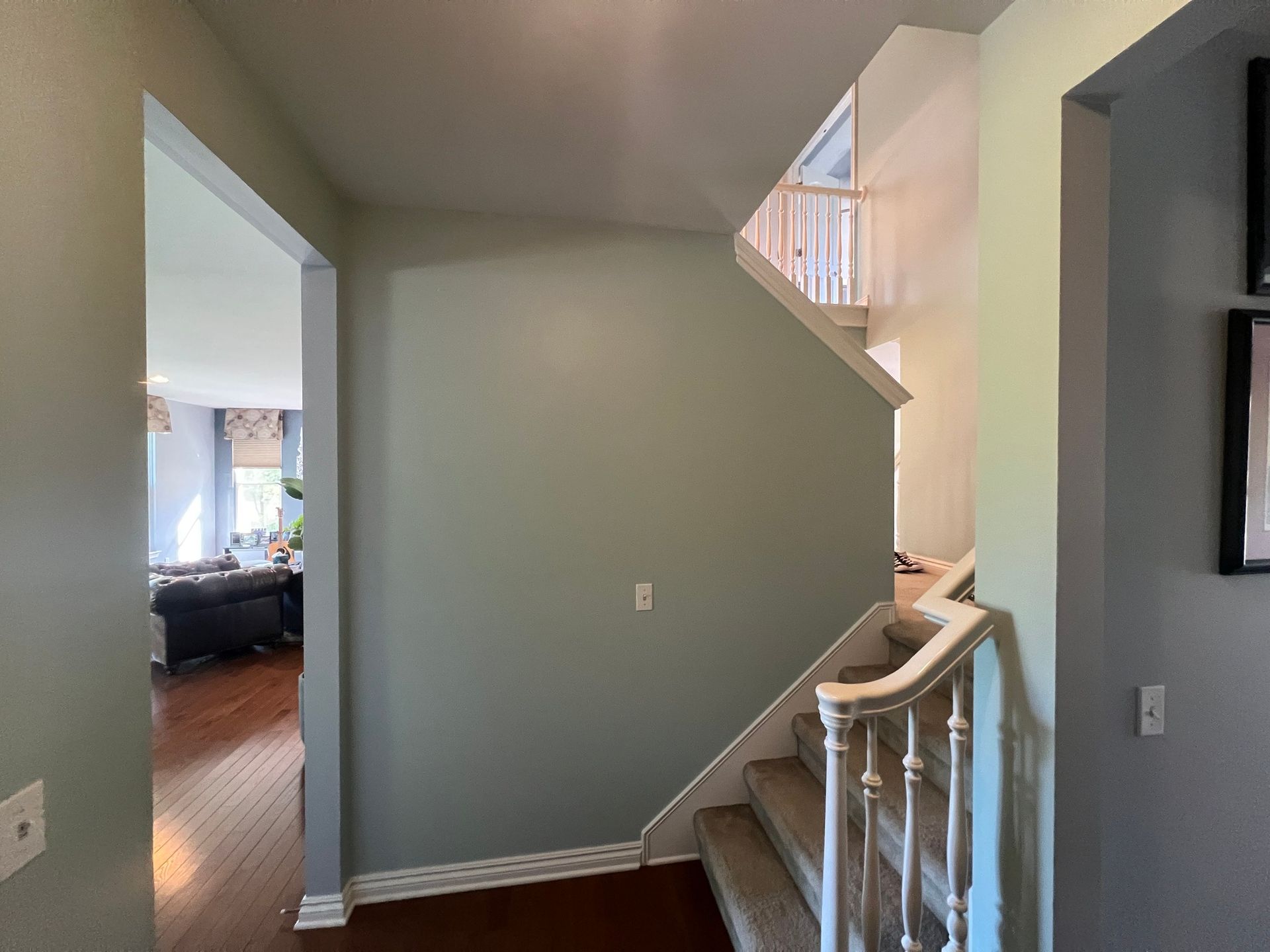 A hallway with stairs leading up to the second floor of a house.