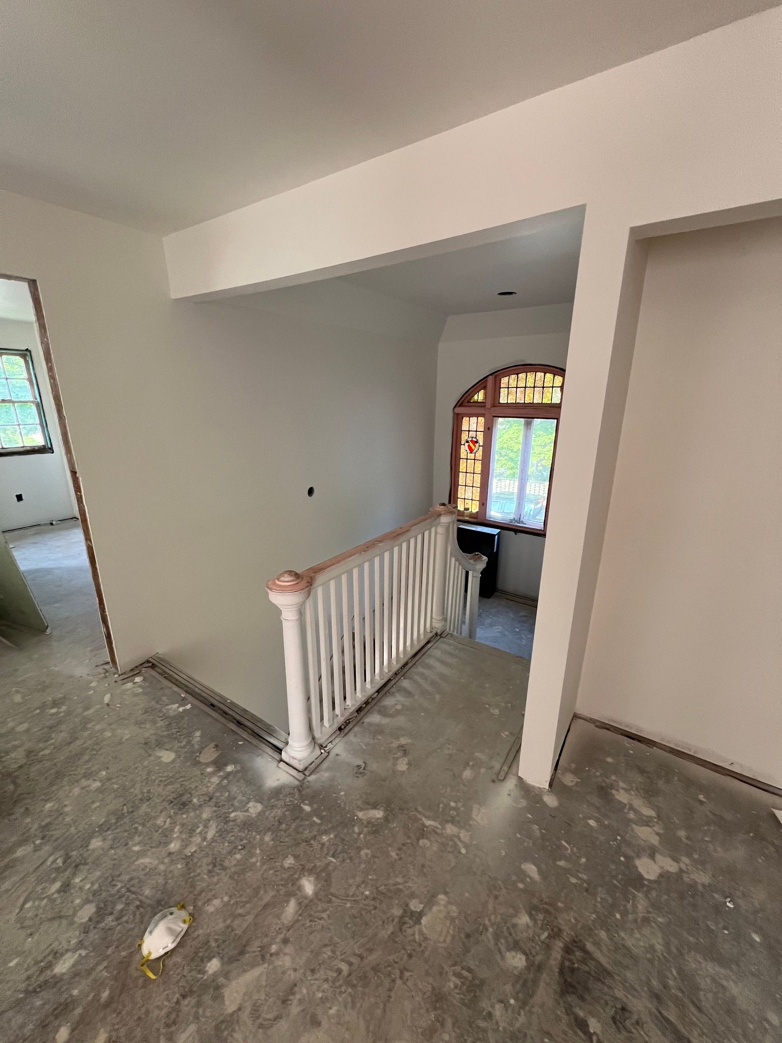 An empty room with a staircase and a window.