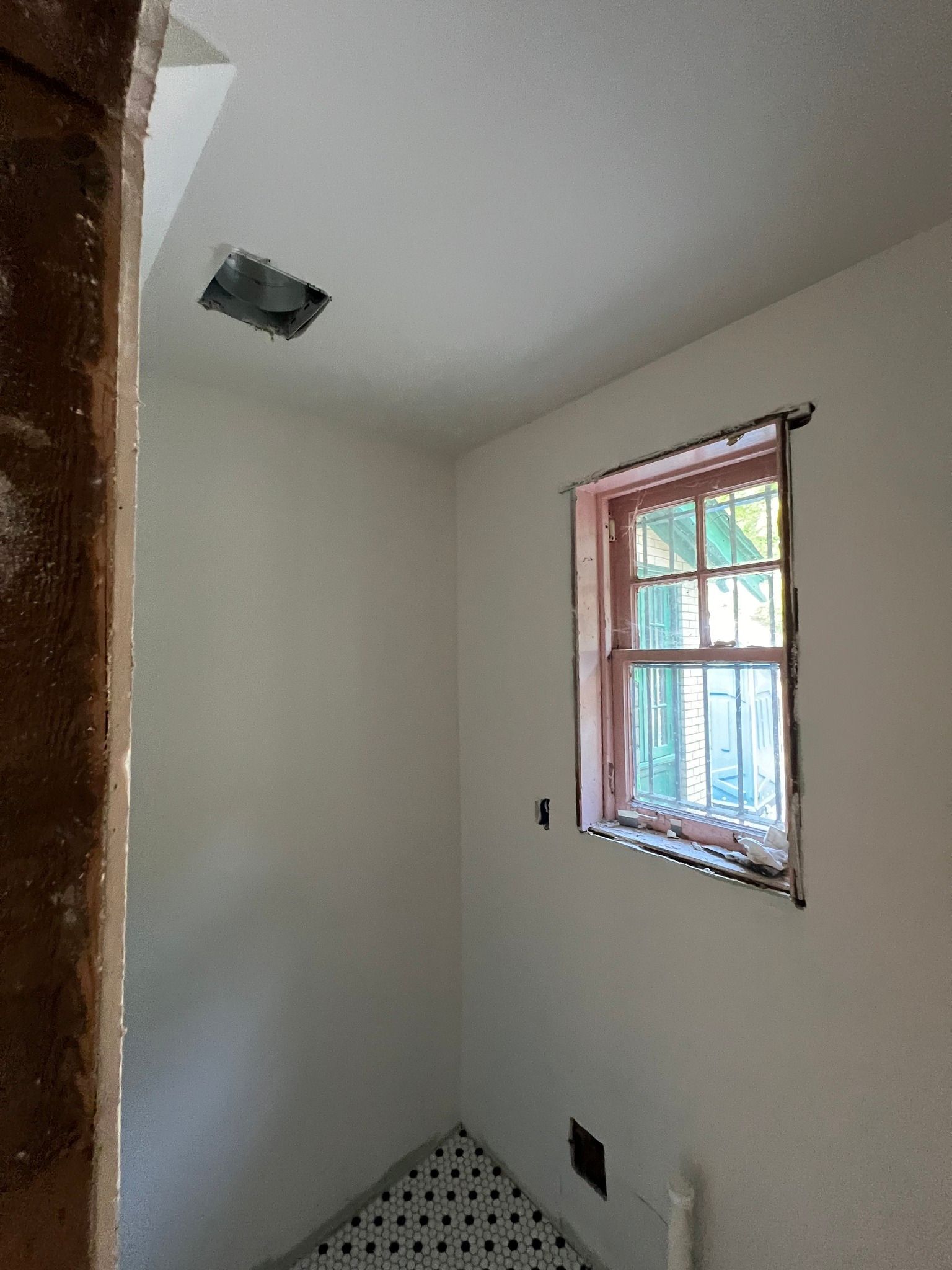 There is a window in the corner of the room.