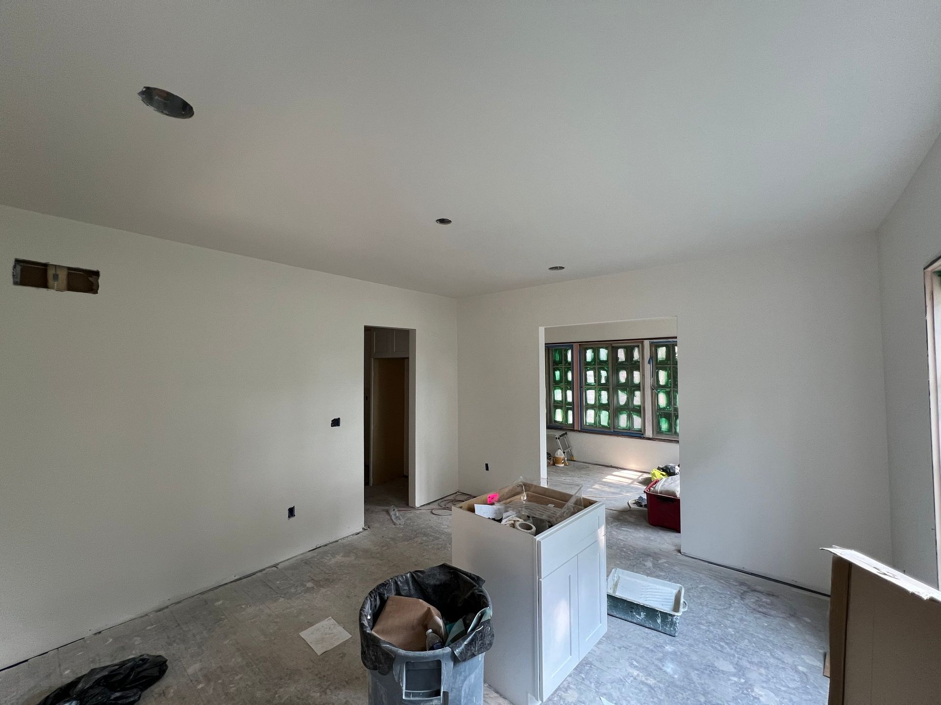 There is a trash can in the middle of the room.