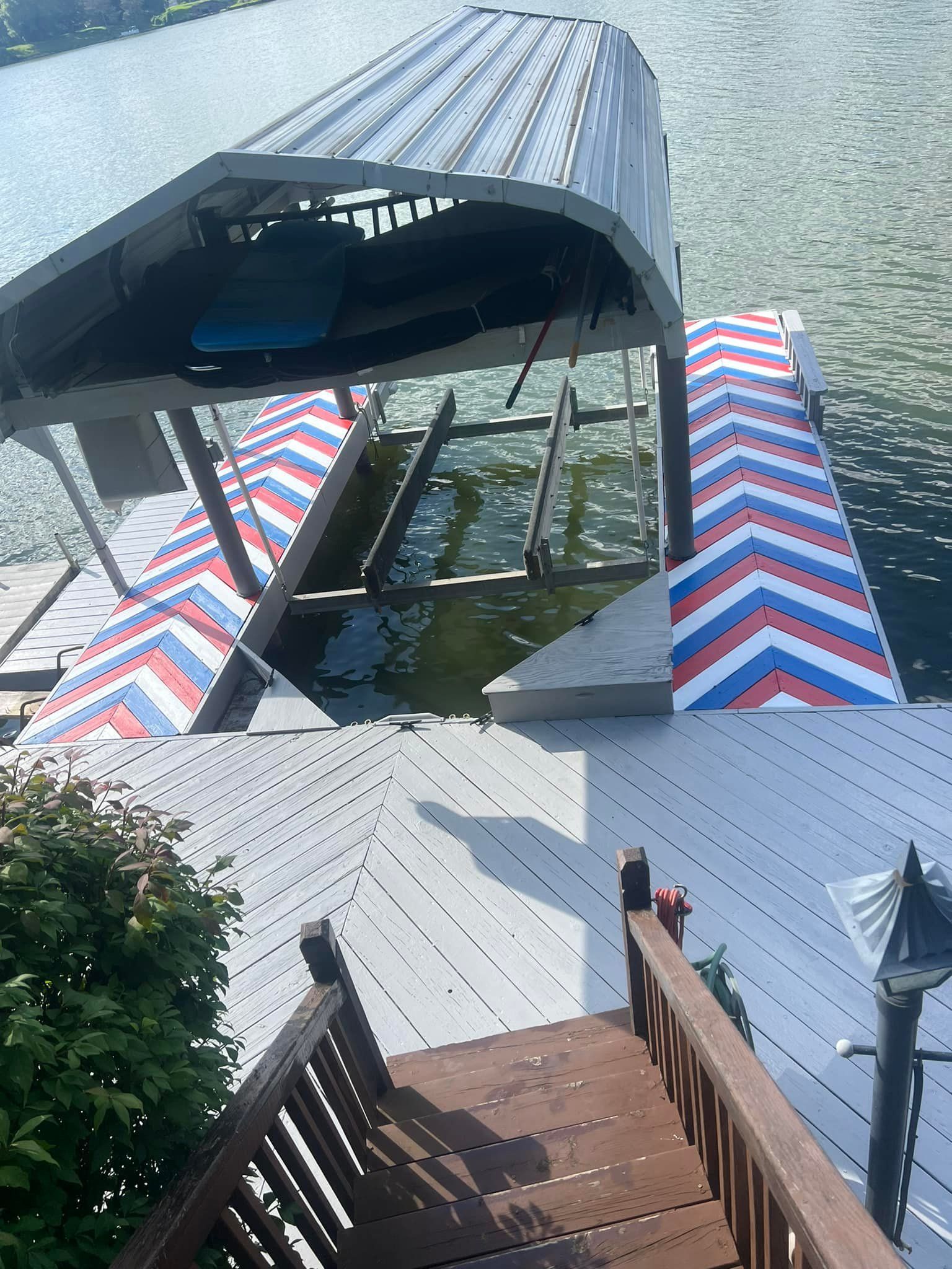 A boat is docked at a dock with stairs leading up to it.