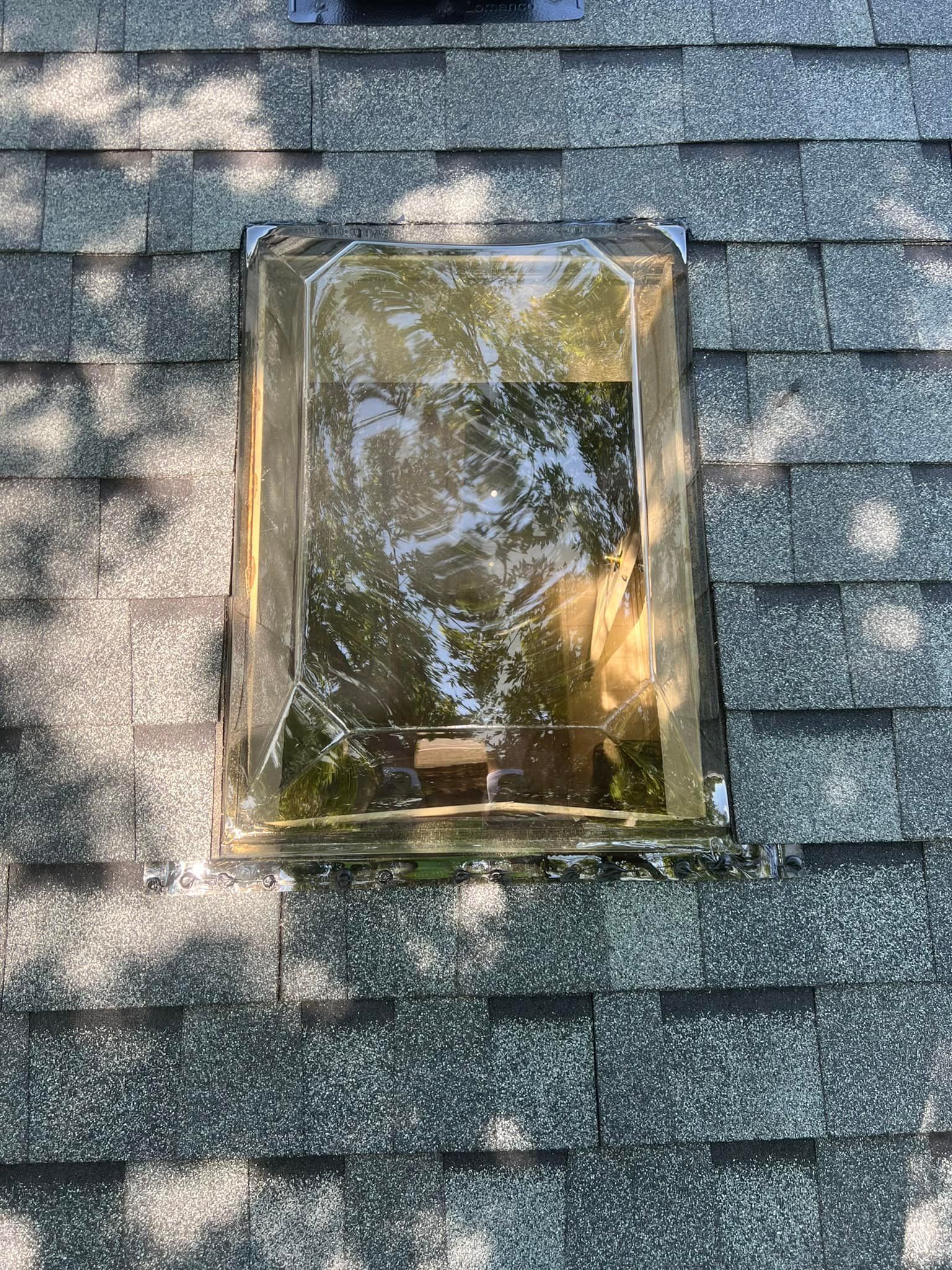 There is a skylight on the roof of a house.
