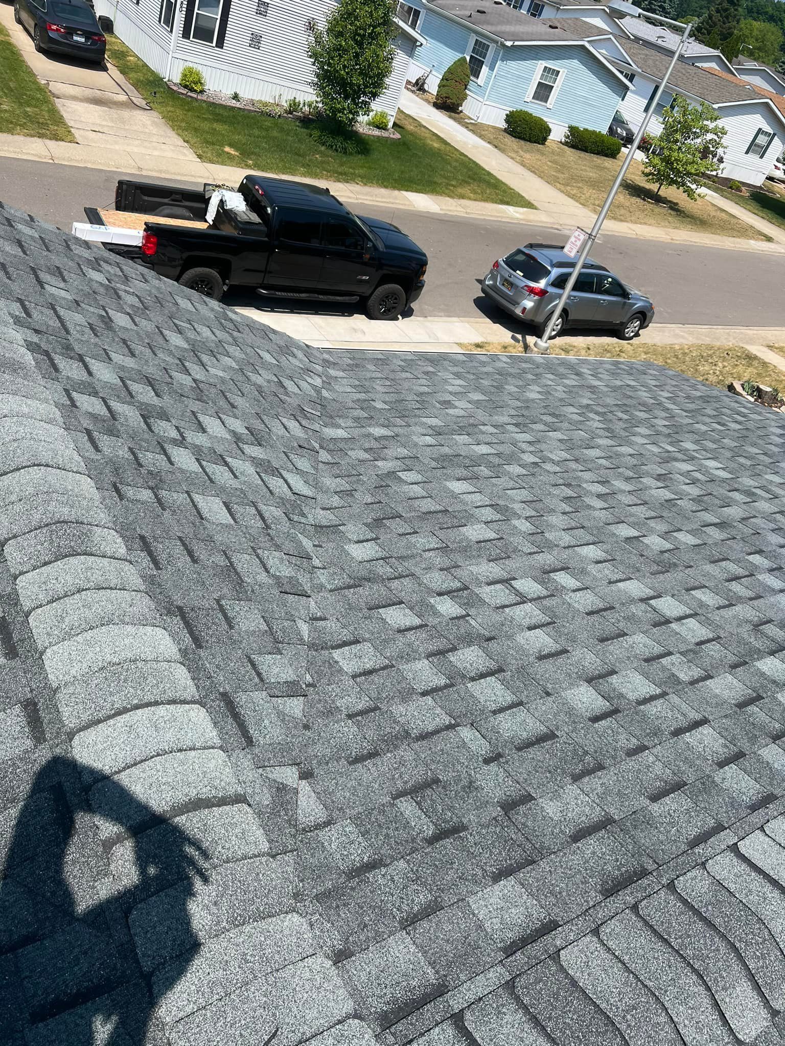 A truck is parked on the roof of a house.