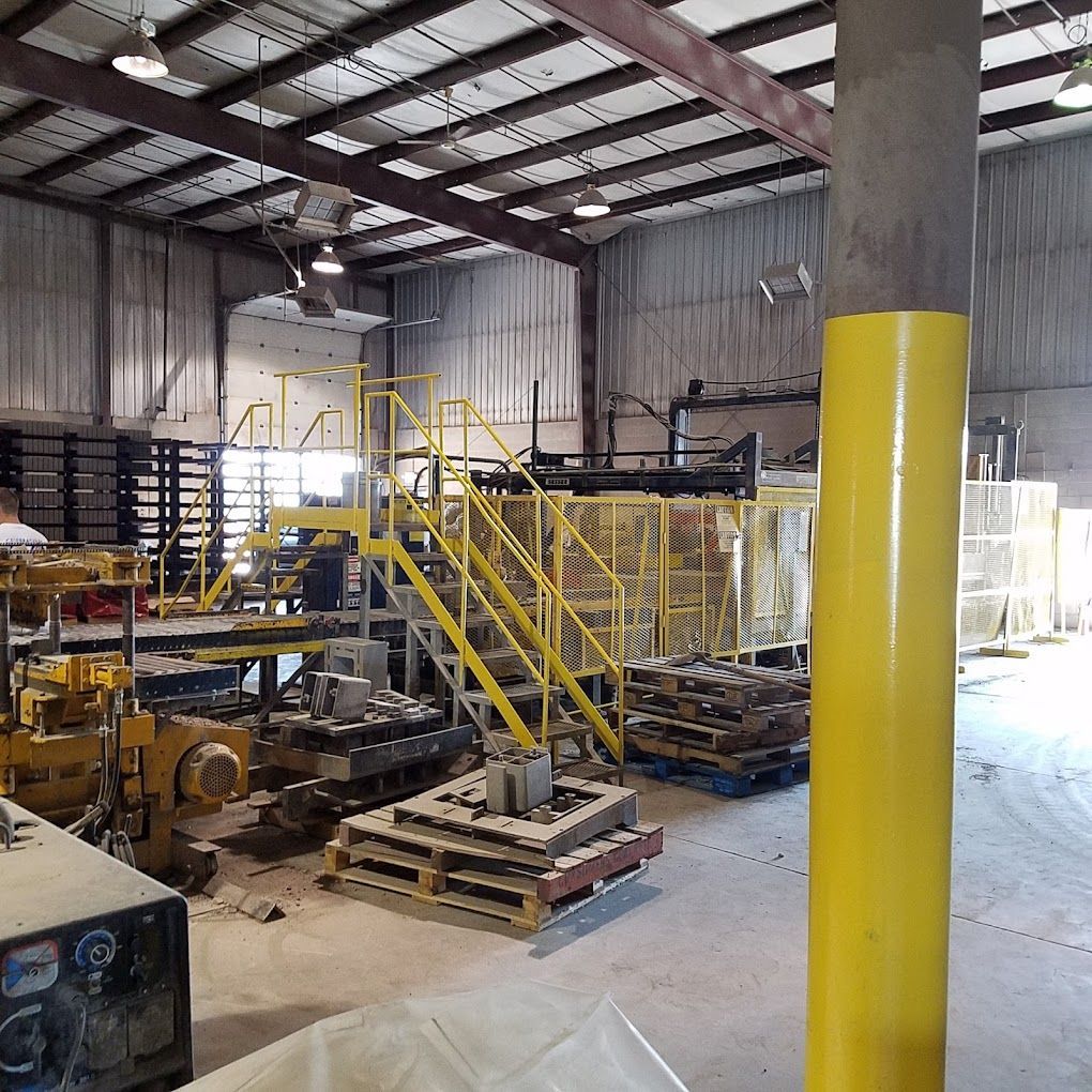A warehouse with yellow stairs and a yellow pole