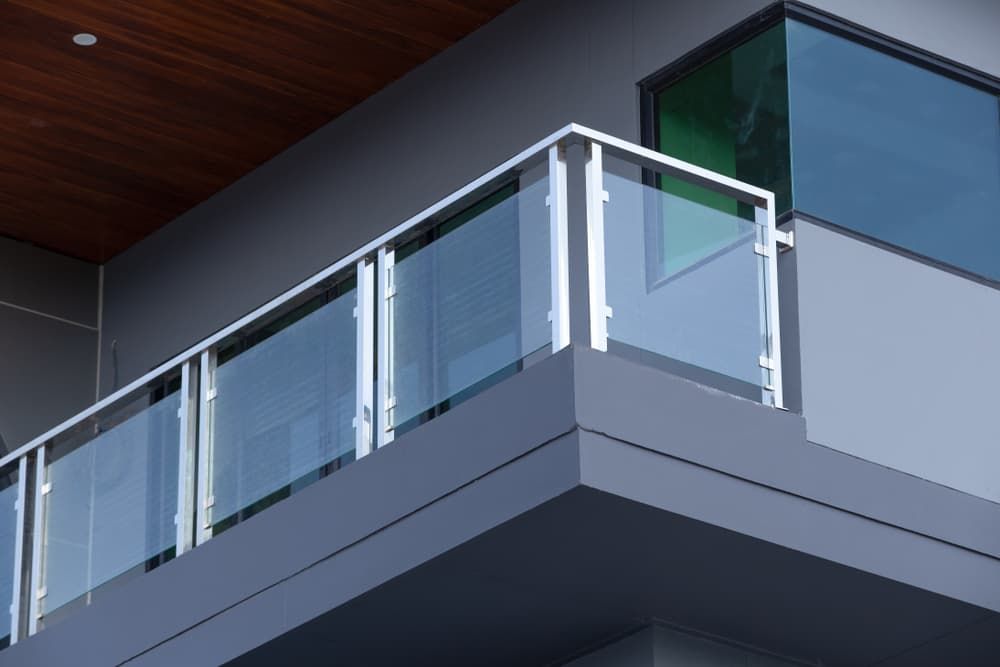 A Balcony with A Glass Railing on The Side of A Building — Gads Glass & Shower Screens in Albion Park, NSW