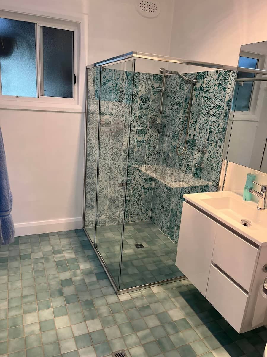 A Bathroom with A Walk in Shower, Sink and Mirror — Gads Glass & Shower Screens in Kiama, NSW