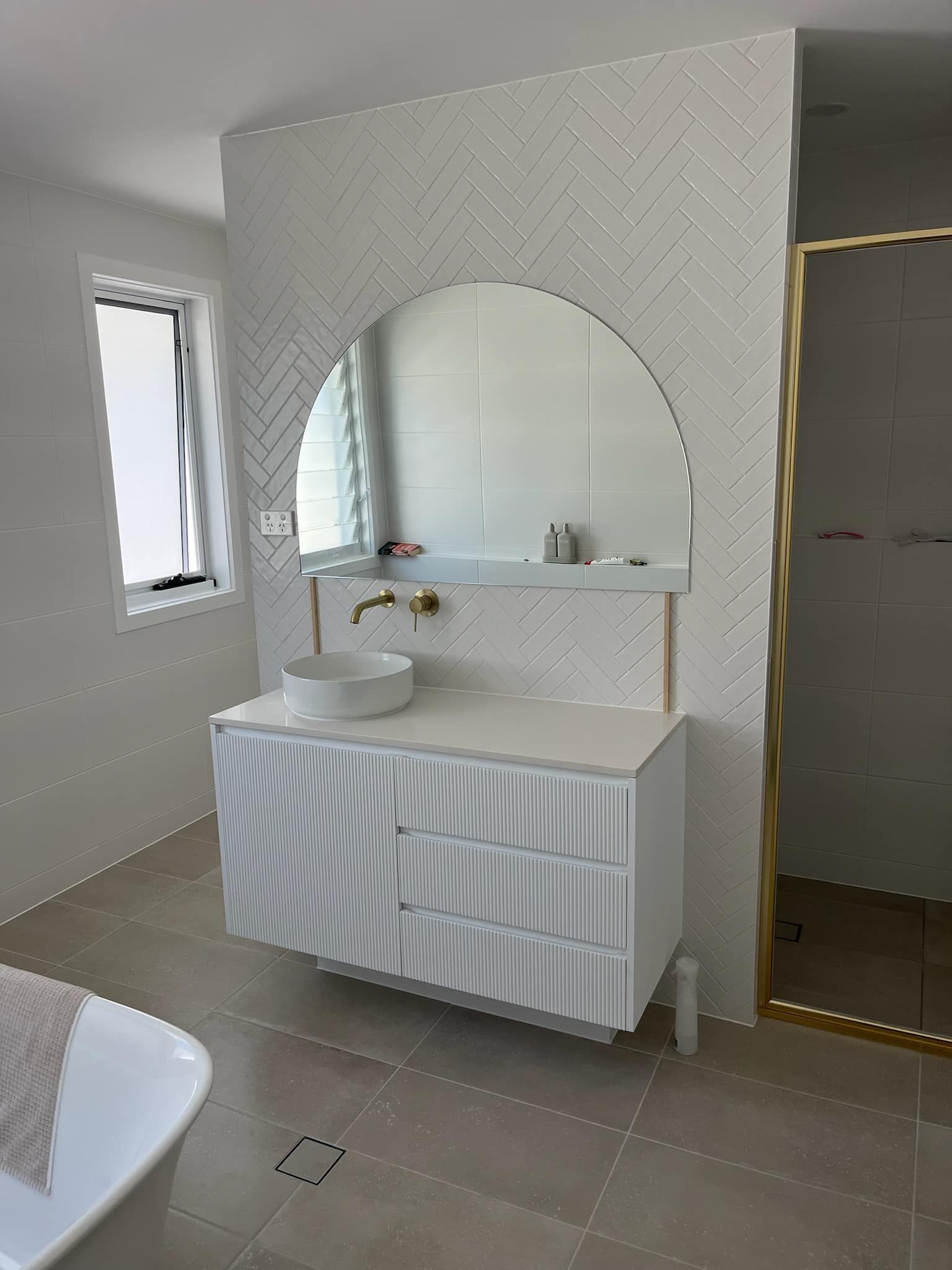 A bathroom with a sink, vanity and mirror on the wall — Gads Glass & Shower Screens in Albion Park, NSW