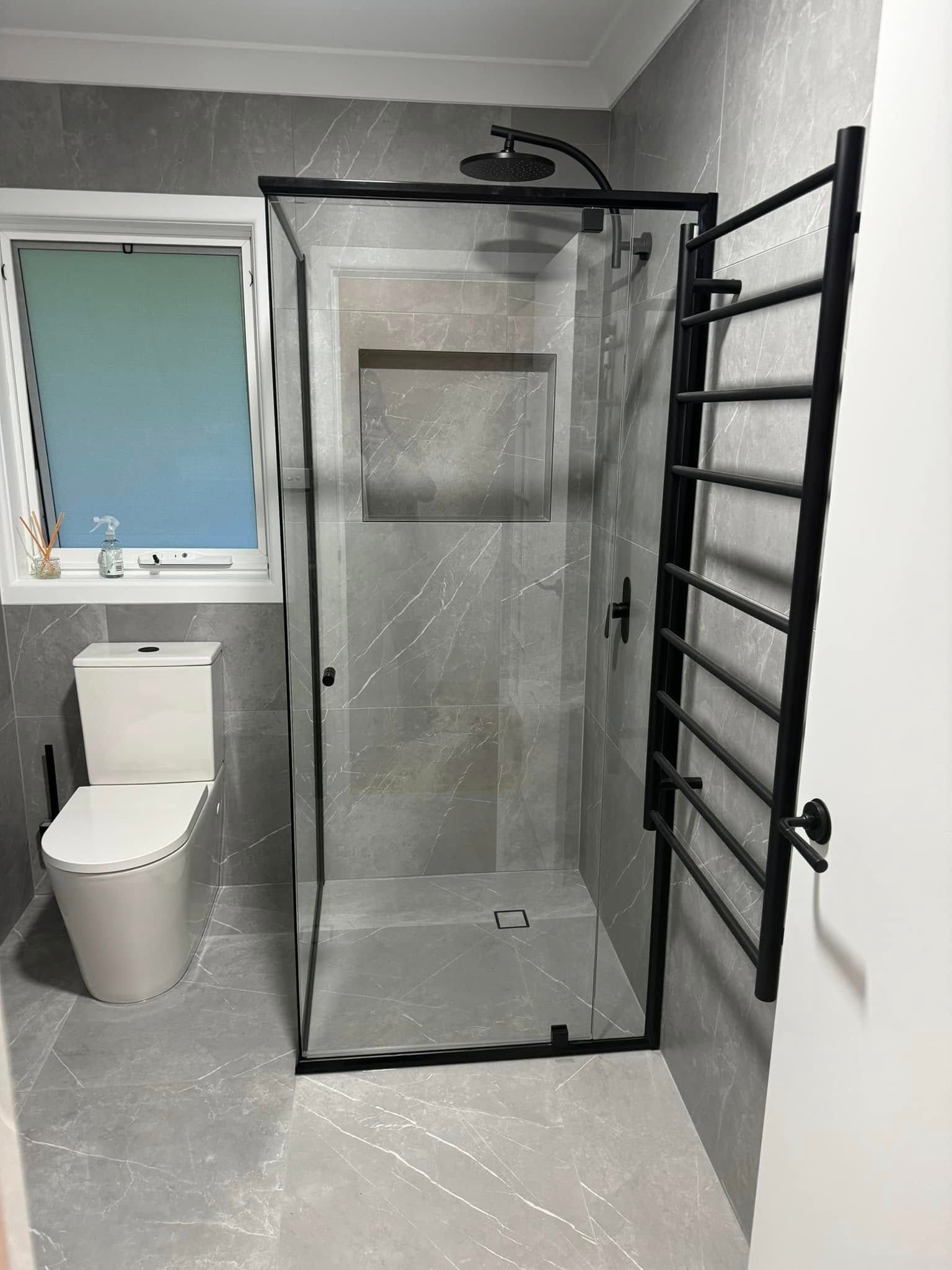 A Bathroom with A Sink, Mirror and Frosted Glass Shower Door — Gads Glass & Shower Screens in Albion Park, NSW