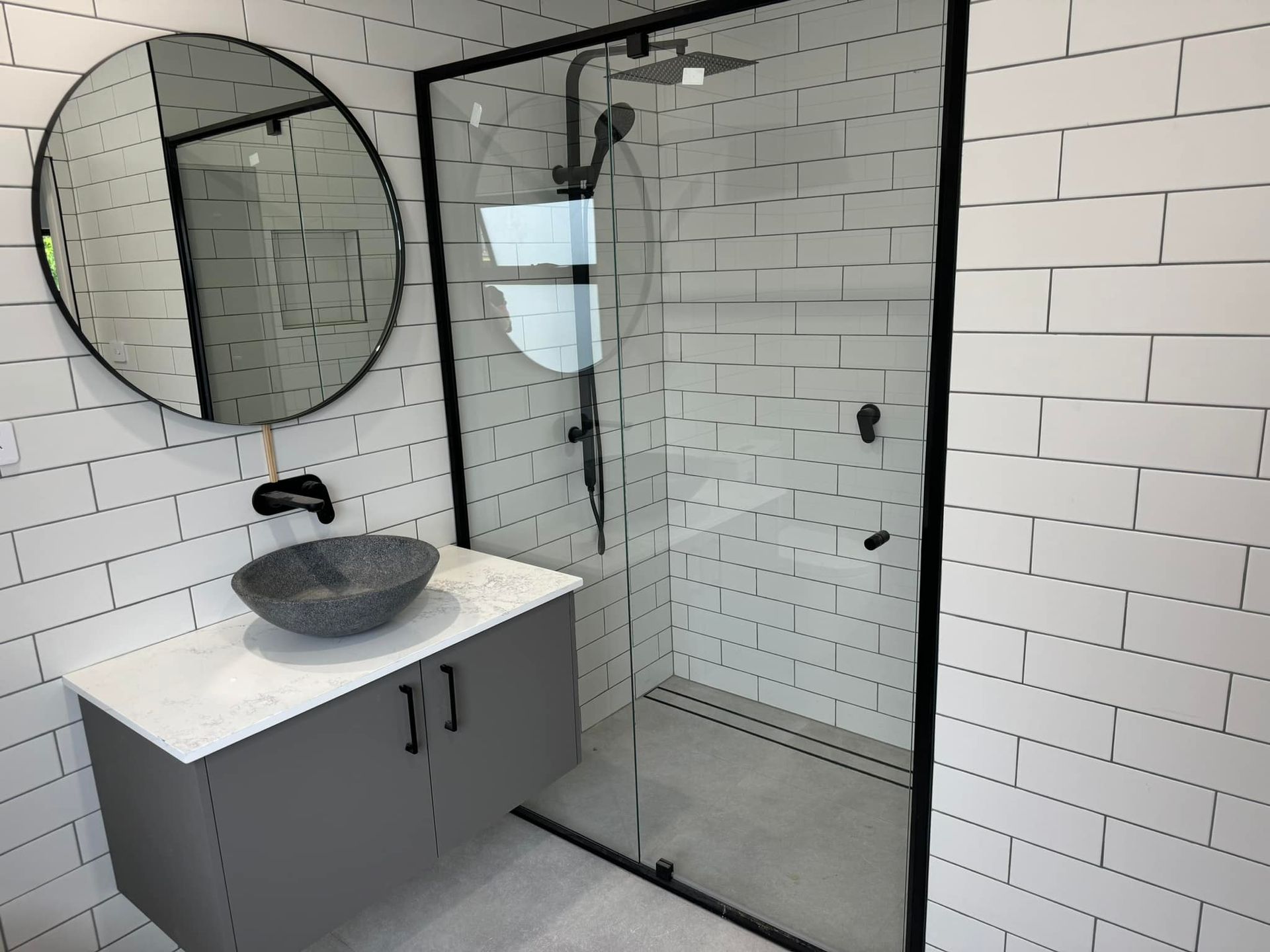 Two Shower Stalls Are Sitting Next to Each Other in A Room — Gads Glass & Shower Screens in Albion Park, NSW