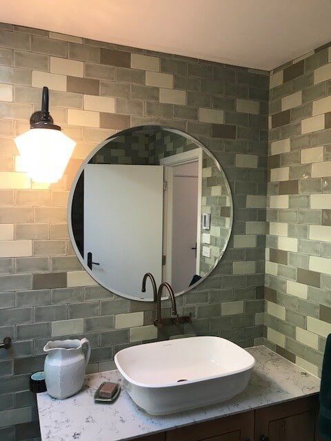 A Bathroom with A Sink and A Round Mirror — Gads Glass & Shower Screens in Albion Park, NSW