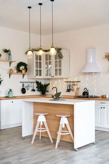 Modern Kitchen Interior with Island, Sink, Cabinets in New Luxury Home Decorated in Christmas Style.