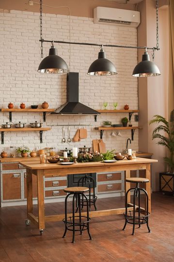 Christmas kitchen decor and copy space. Rustic cuisine at Christmas. Details of scandinavian cuisine in bronze color. Kitchen island table with festive table setting