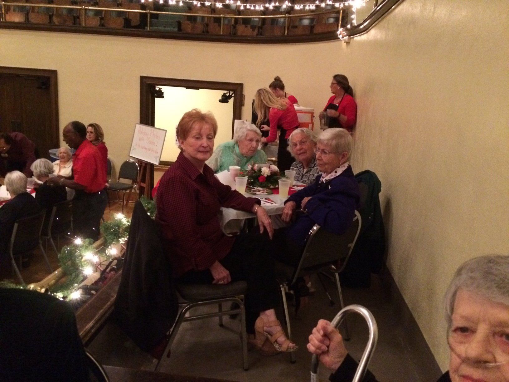 A group of people are sitting at tables in a room.