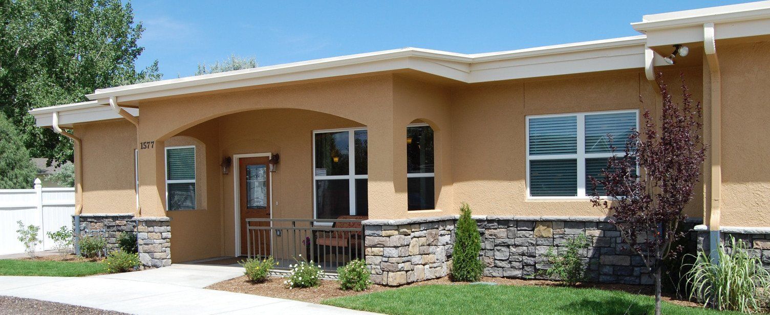 A house with a lot of windows and a walkway in front of it
