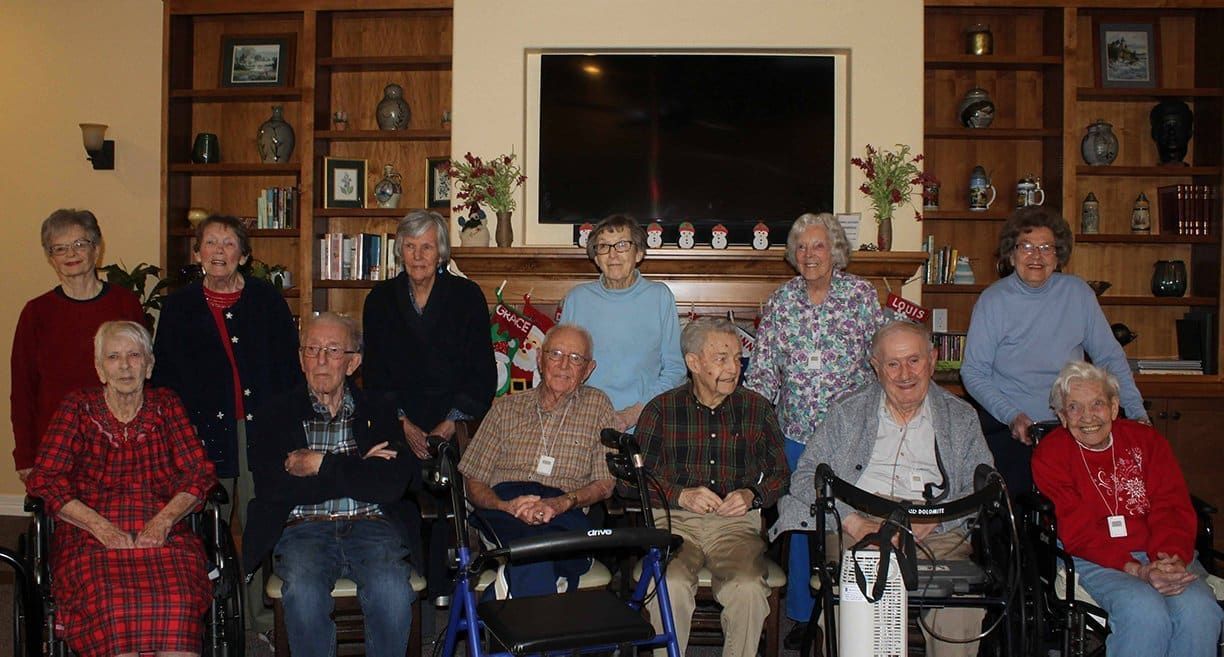 A group of elderly people are posing for a picture