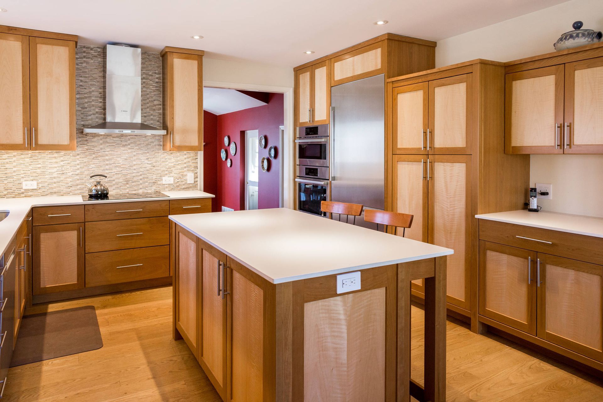 A kitchen with stainless steel appliances and wooden cabinets