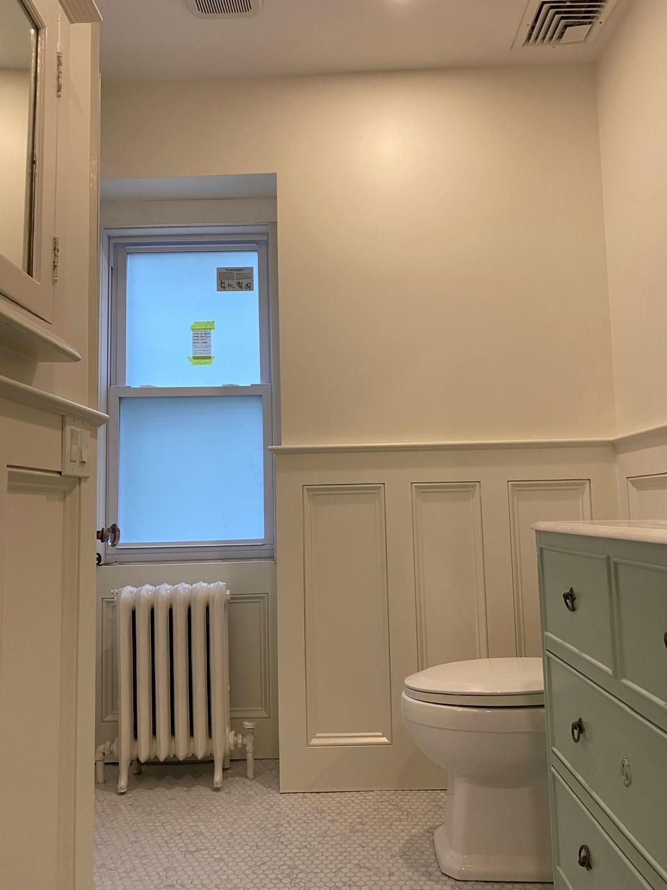 A bathroom with a toilet , sink , mirror and radiator. James McCoy Remodeling Services Serving 19072,19003,19118,19444,19095 and surrounding areas