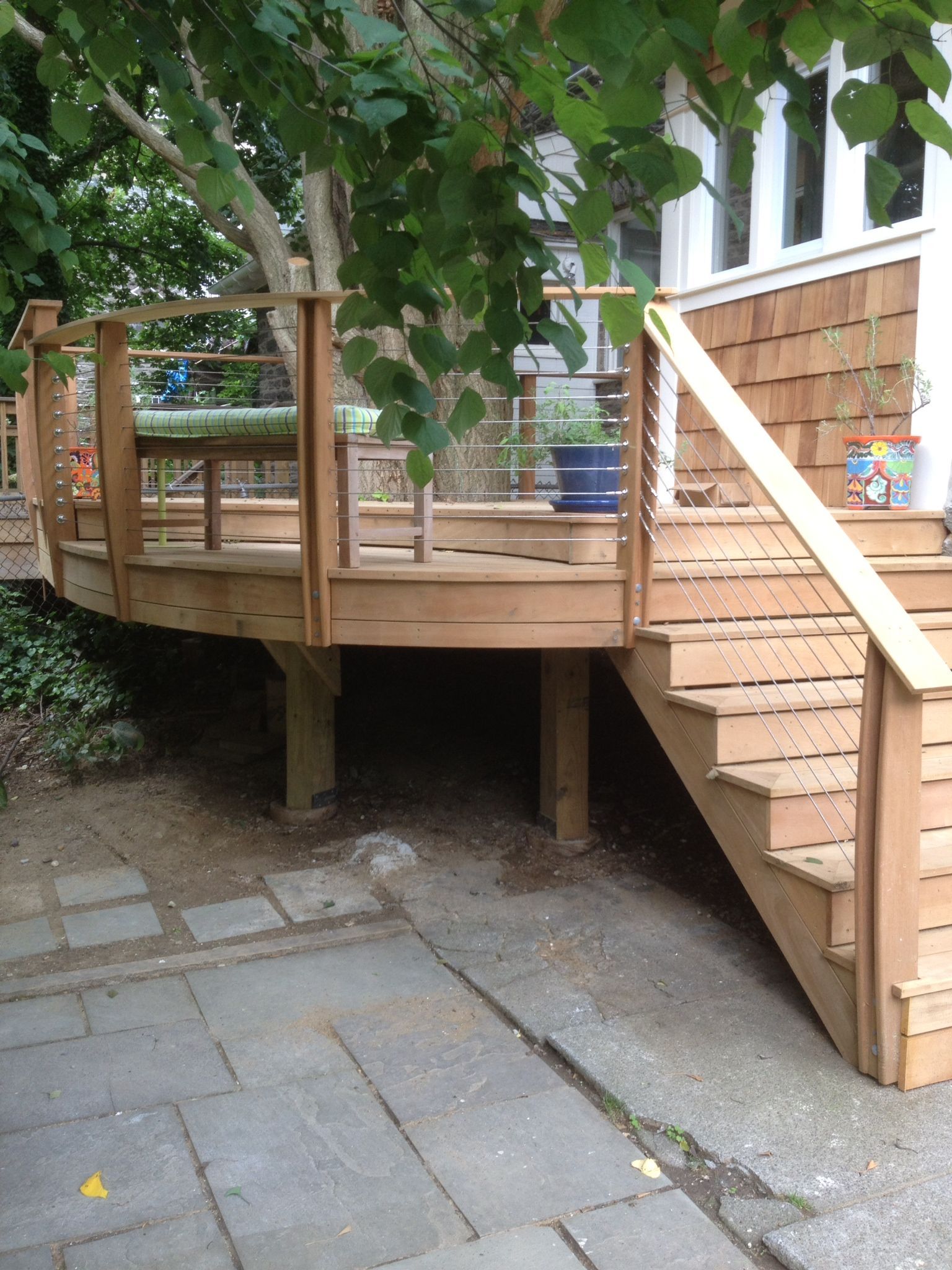 A wooden deck with stairs leading up to it