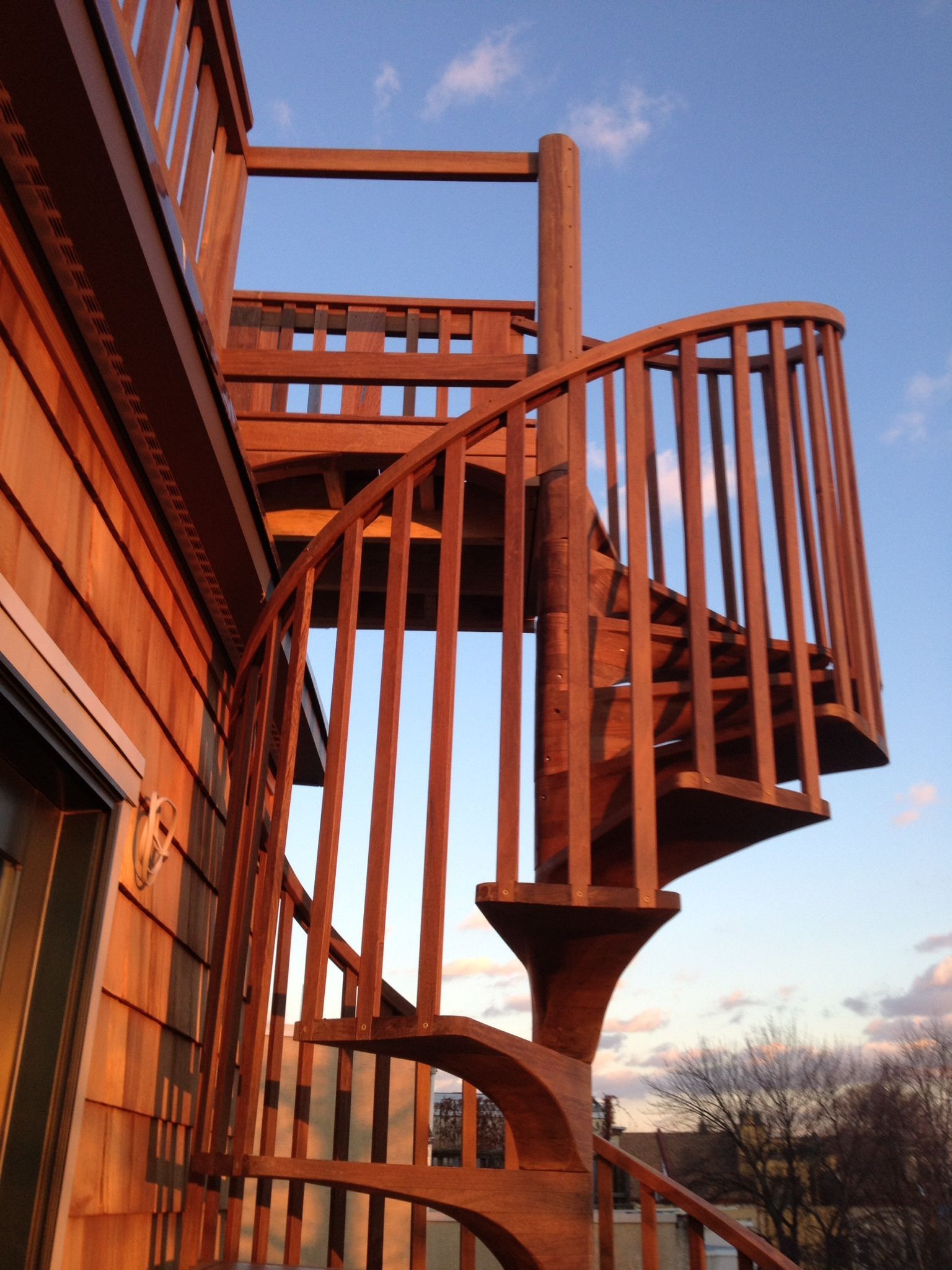 A wooden spiral staircase on the side of a building. James McCoy Remodeling Services Serving 19072,19003,19118,19444,19095 and surrounding areas
