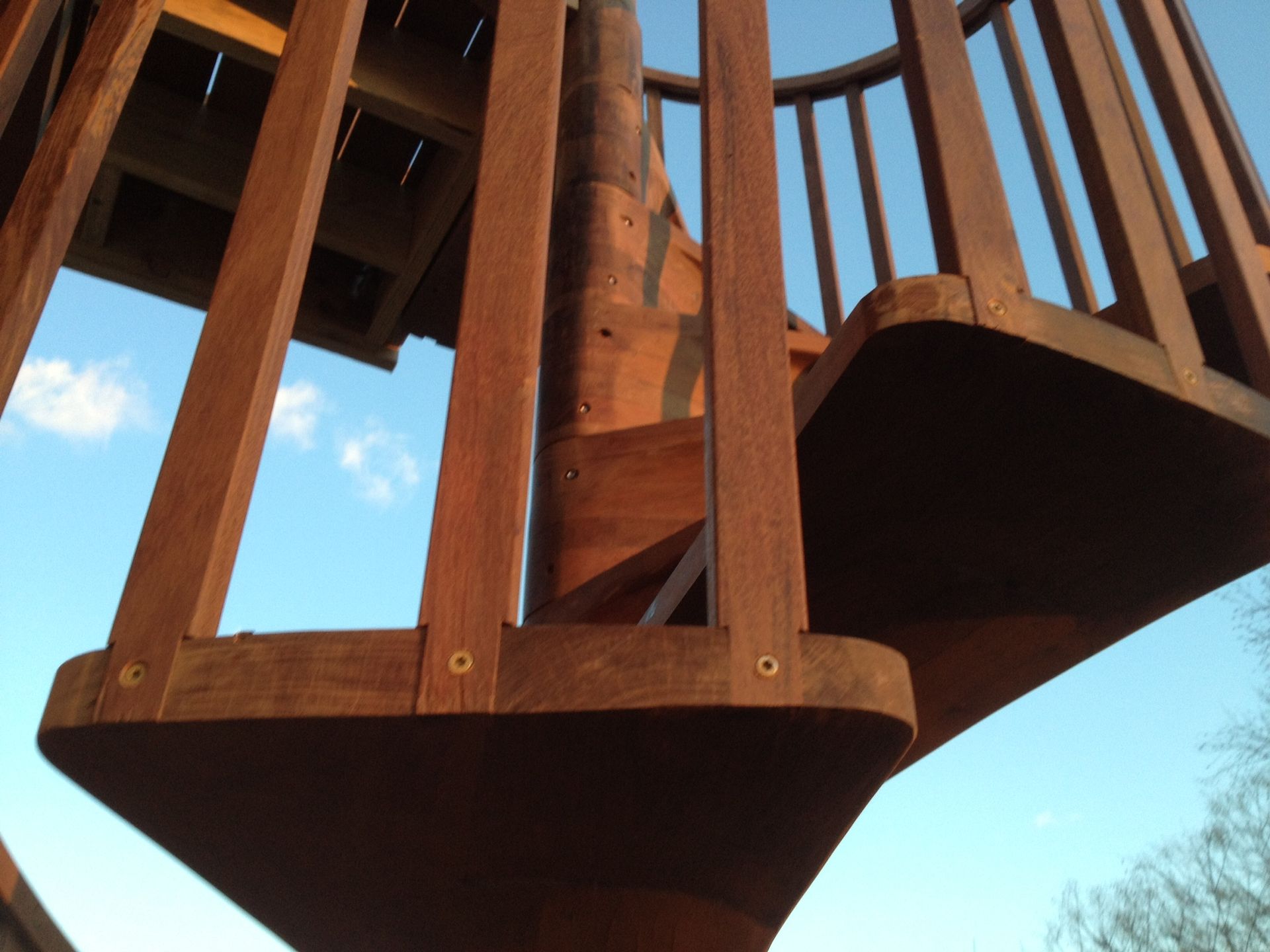 A wooden staircase with a blue sky in the background. James McCoy Remodeling Services Serving 19072,19003,19118,19444,19095 and surrounding areas