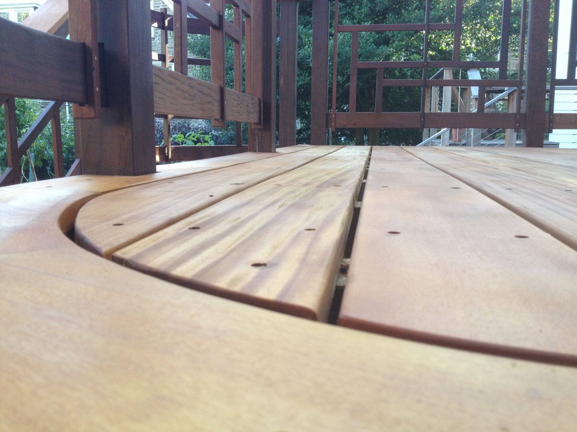 A close up of a wooden deck with a fence in the background. James McCoy Remodeling Services Serving 19072,19003,19118,19444,19095 and surrounding areas