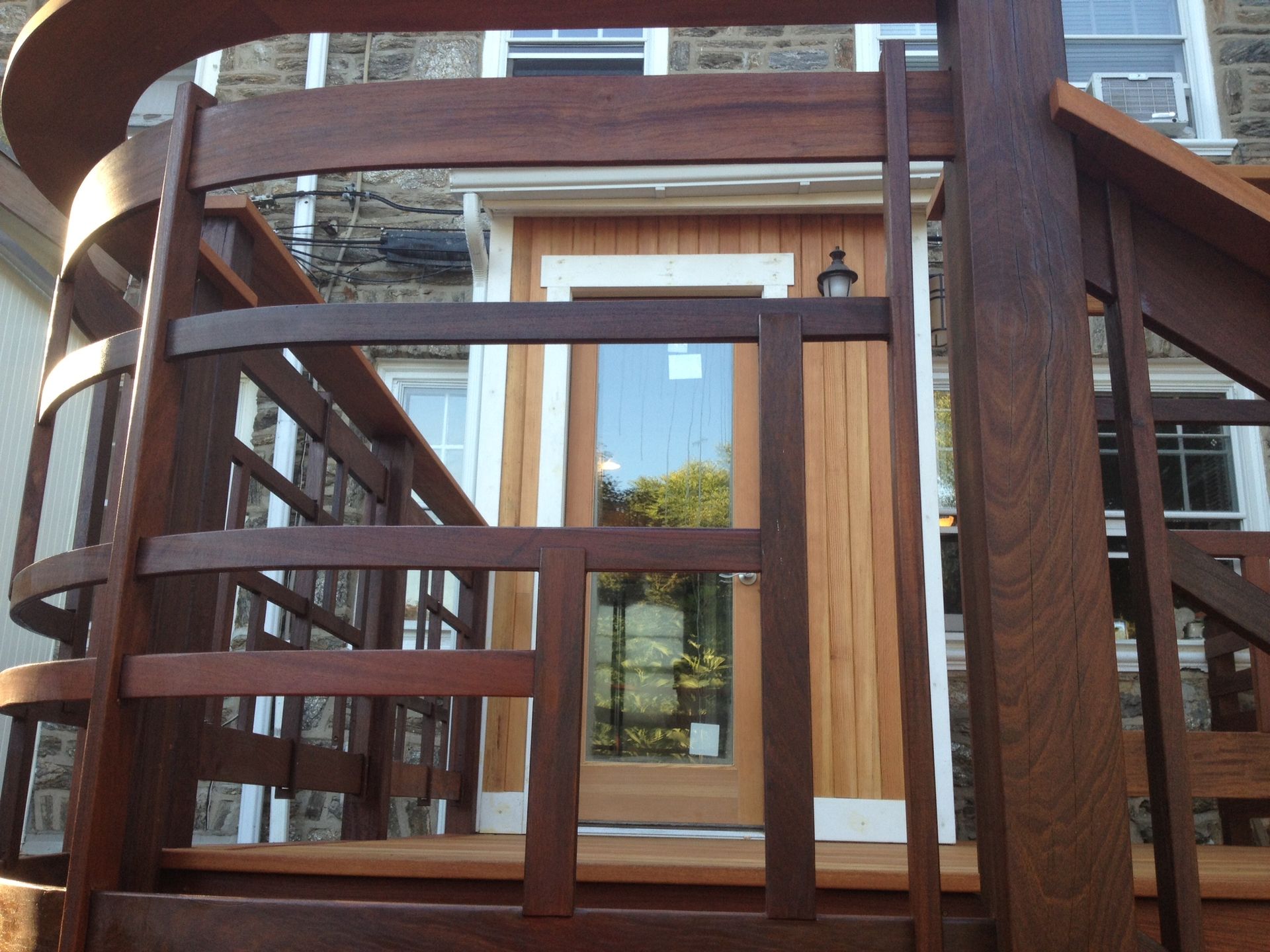 A wooden staircase leading up to a wooden door. James McCoy Remodeling Services Serving 19072,19003,19118,19444,19095 and surrounding areas