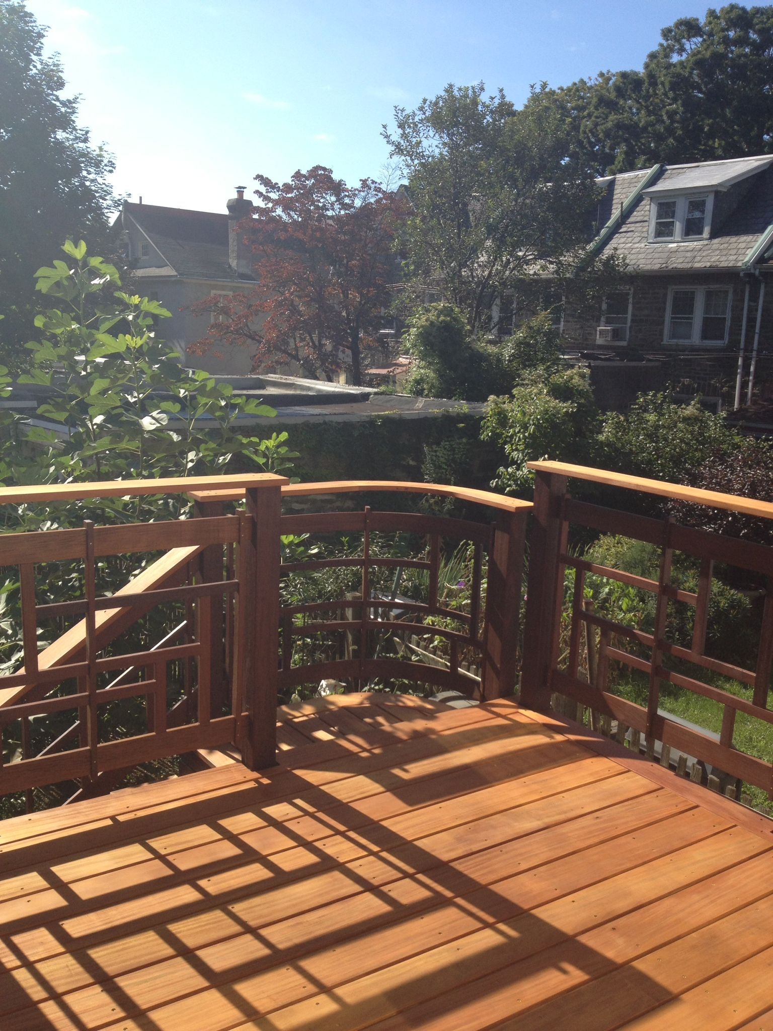 A wooden deck with a fence and a view of a house. James McCoy Remodeling Services Serving 19072,19003,19118,19444,19095 and surrounding areas