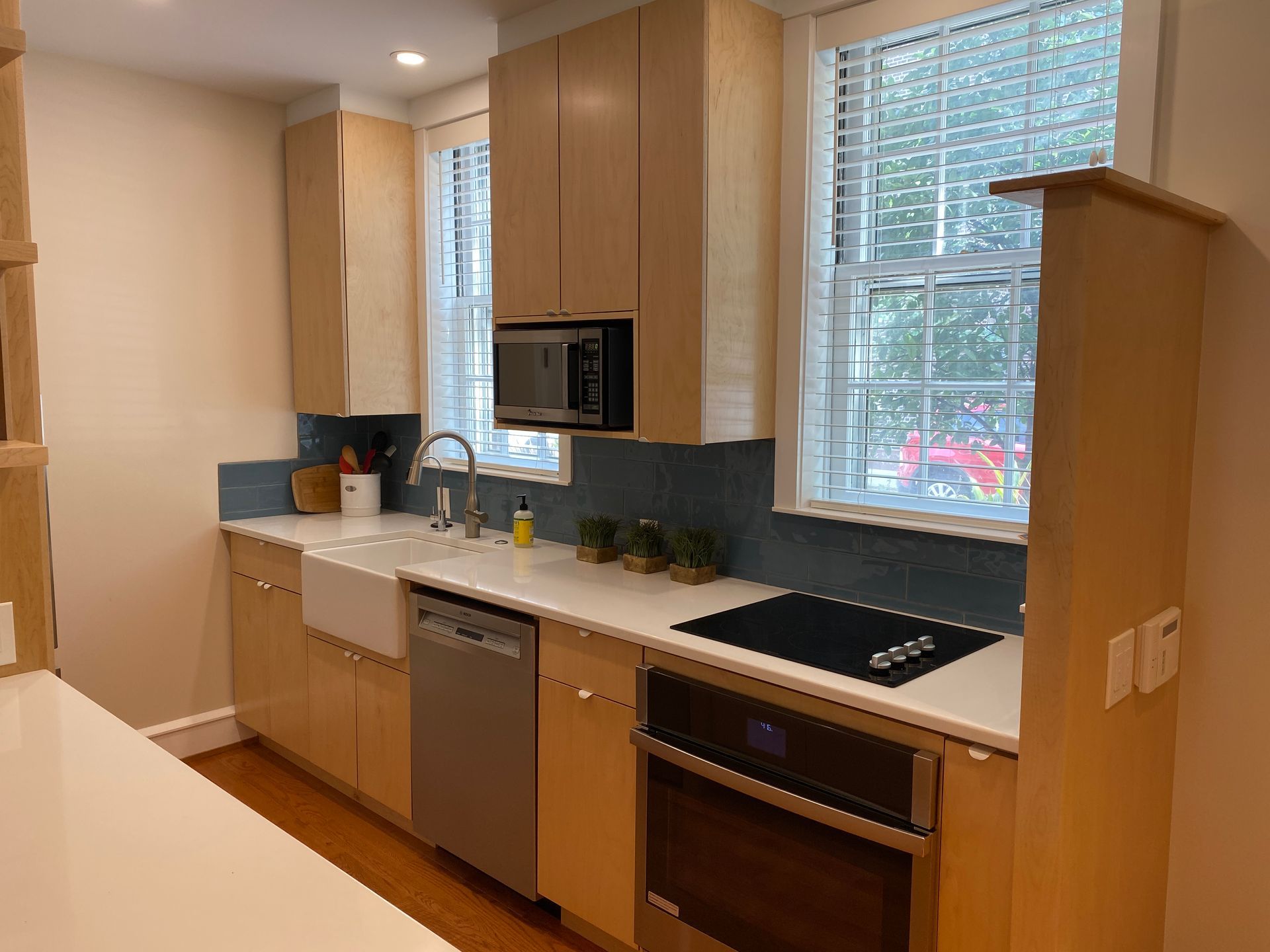 A kitchen with stainless steel appliances and wooden cabinets