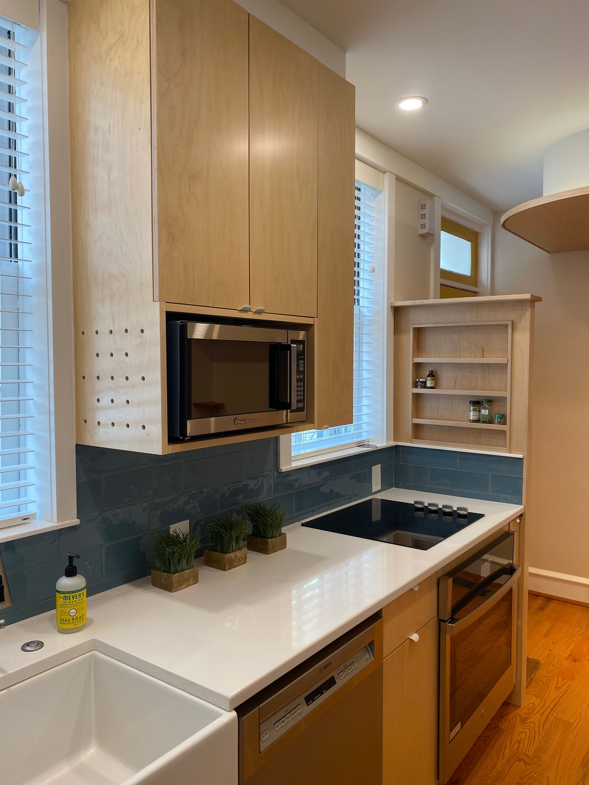 A kitchen with stainless steel appliances and wooden cabinets