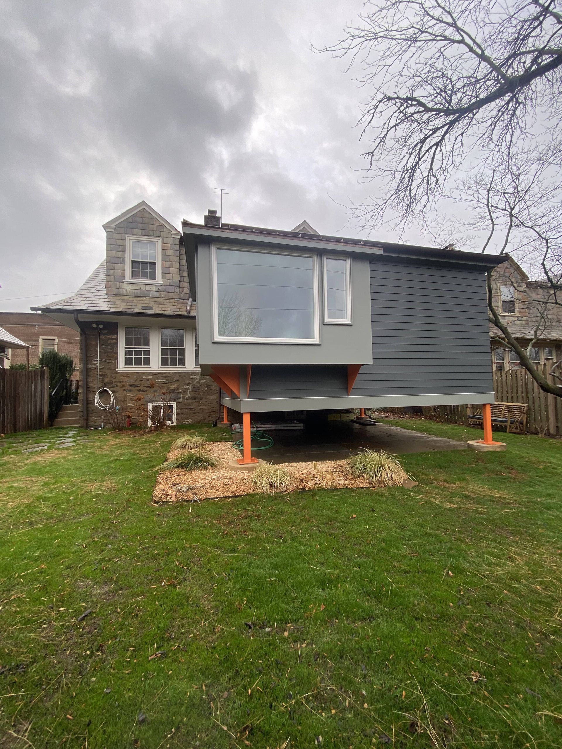 A contemporary residential extension with orange supports.James McCoy Remodeling Services Serving 19072,19003,19118,19444,19095 and surrounding areas