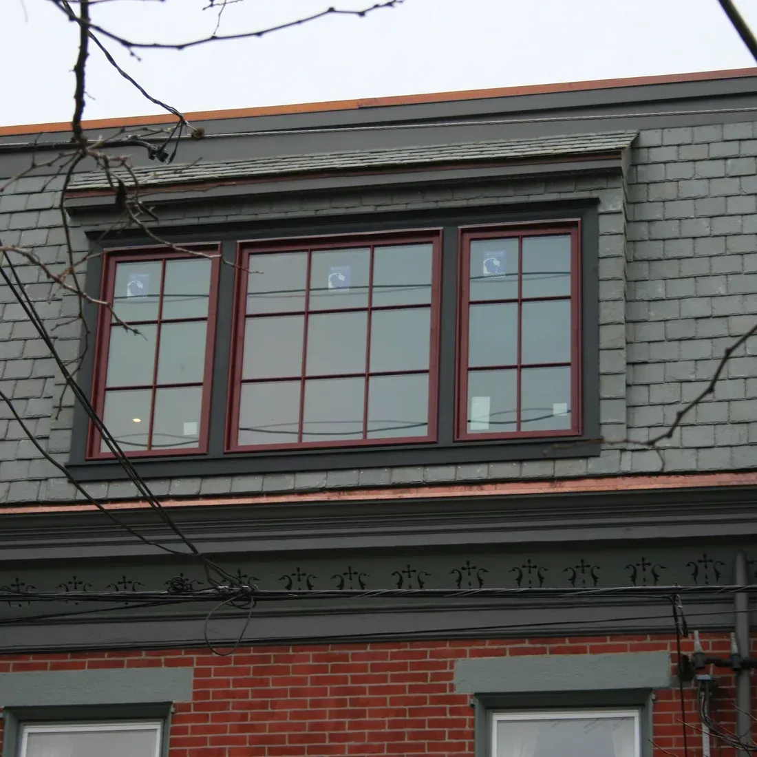 A brick building with a slate roof and two windows .James McCoy Remodeling Services Serving 19072,19003,19118,19444,19095 and surrounding areas