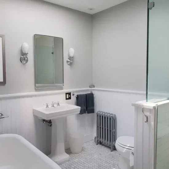 A bathroom with a sink toilet and mirror. James McCoy Remodeling Services Serving 19072,19003,19118,19444,19095 and surrounding areas